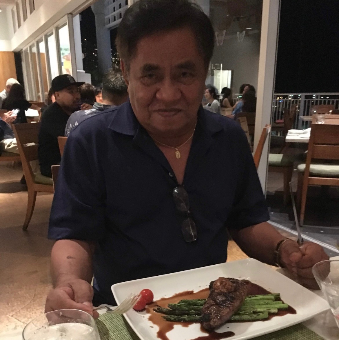 A man sitting at a table with a plate of food