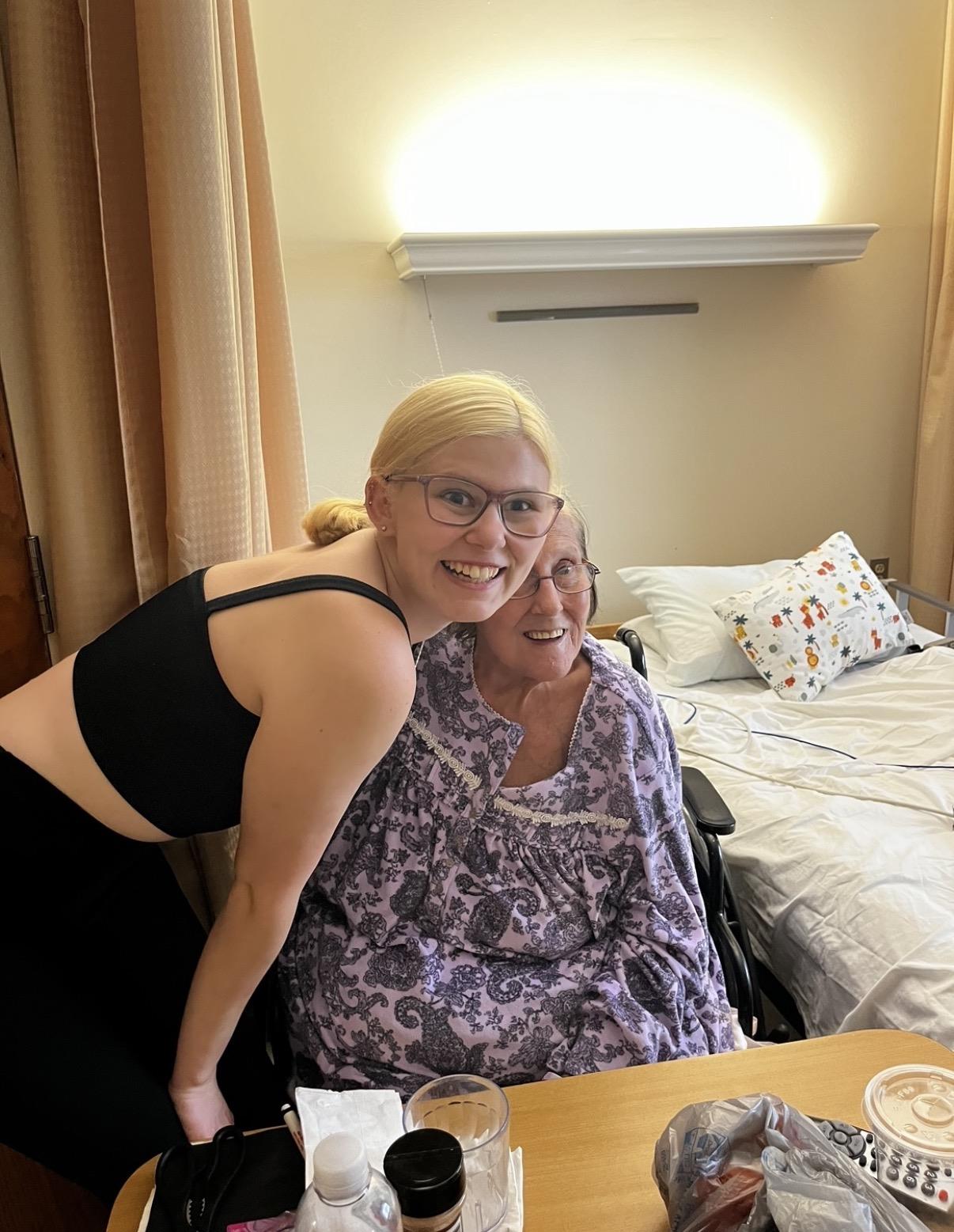 A woman smiling at a woman in a wheelchair
