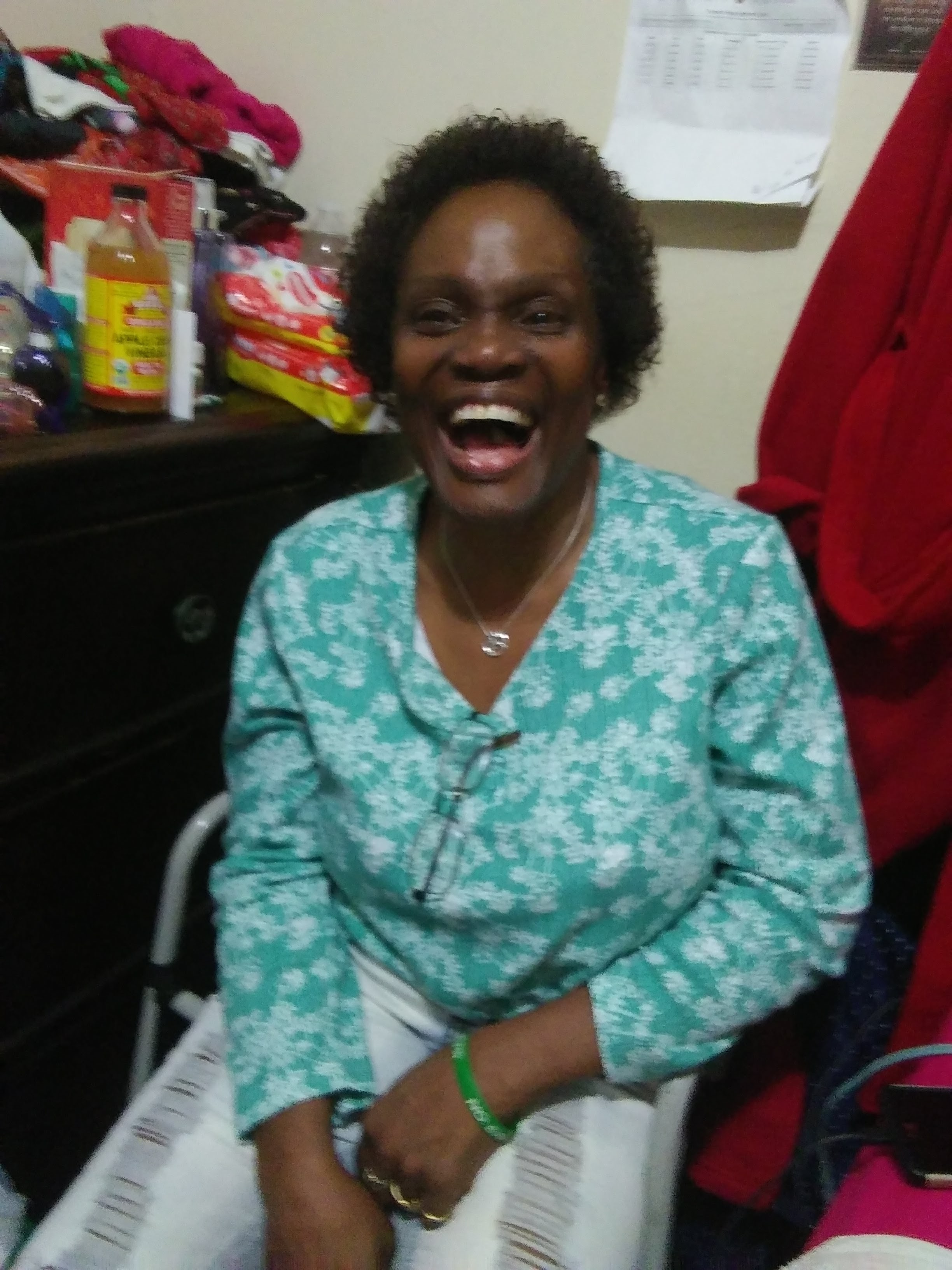 A woman sitting in a wheelchair laughing