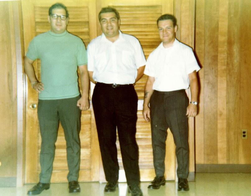 A group of men standing in front of a door