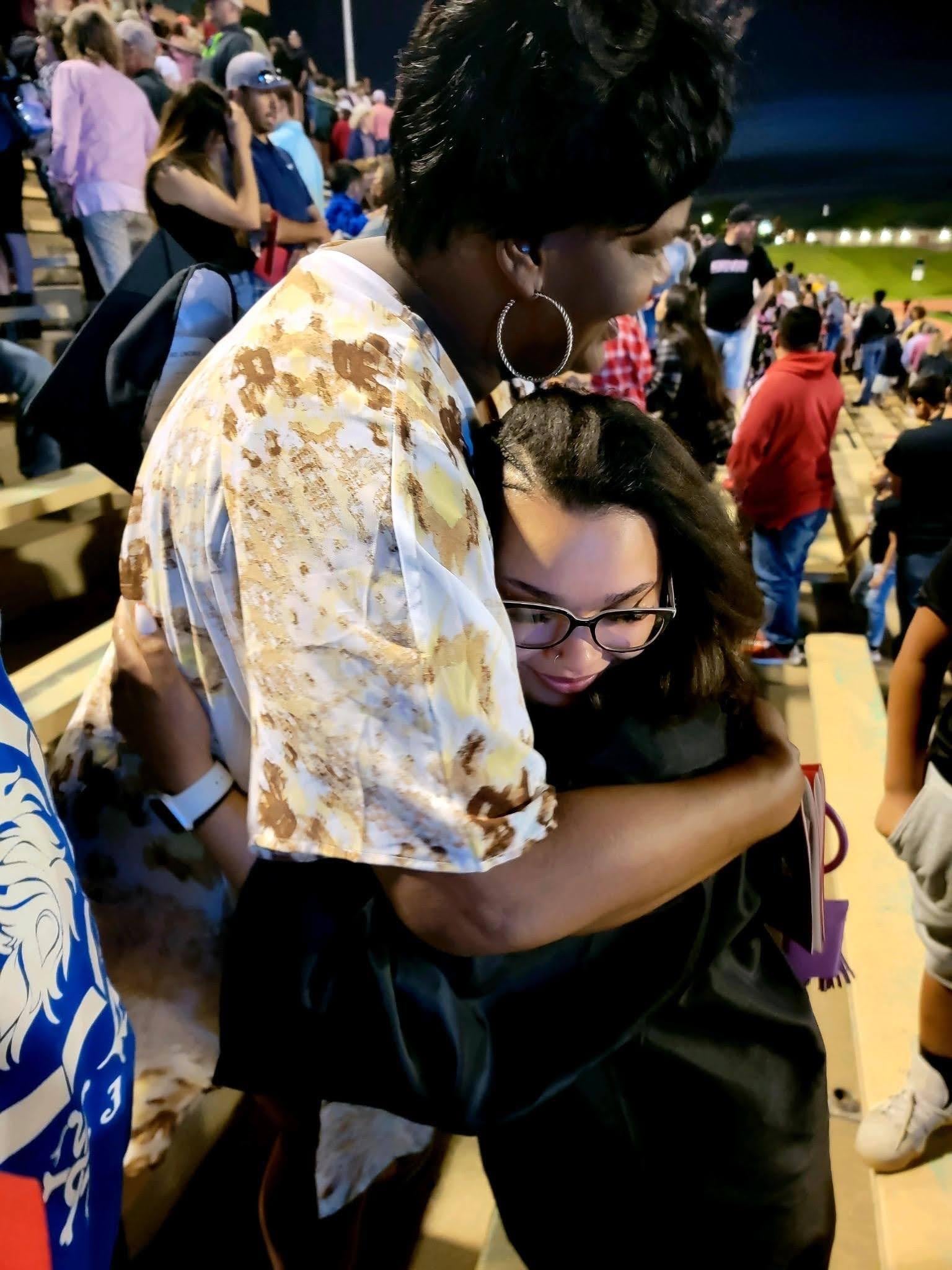 A woman hugging another woman