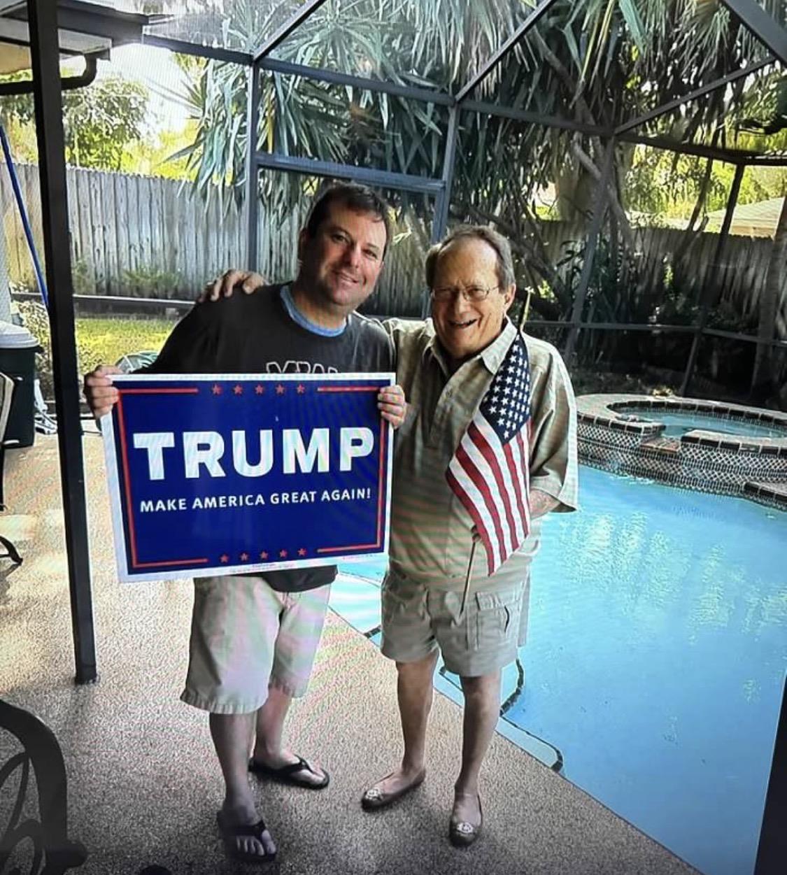 Two men holding a sign