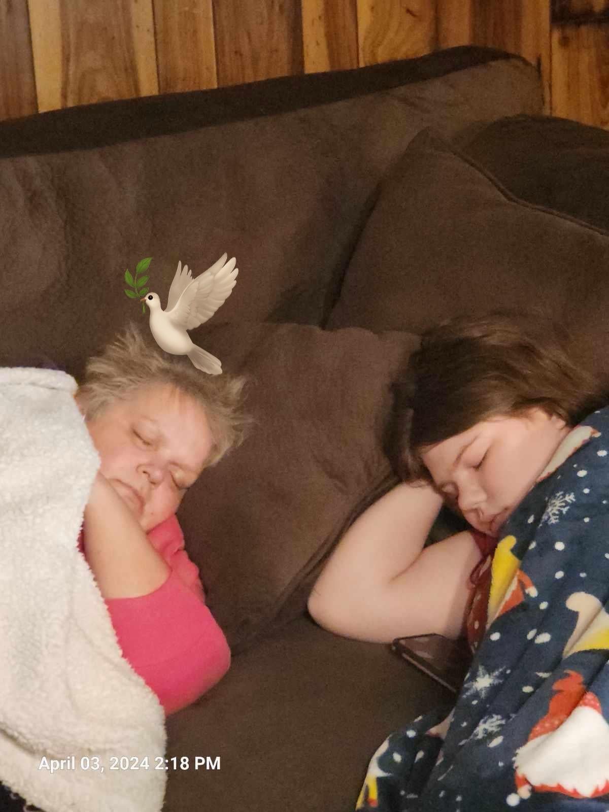 Two people sleeping on a couch