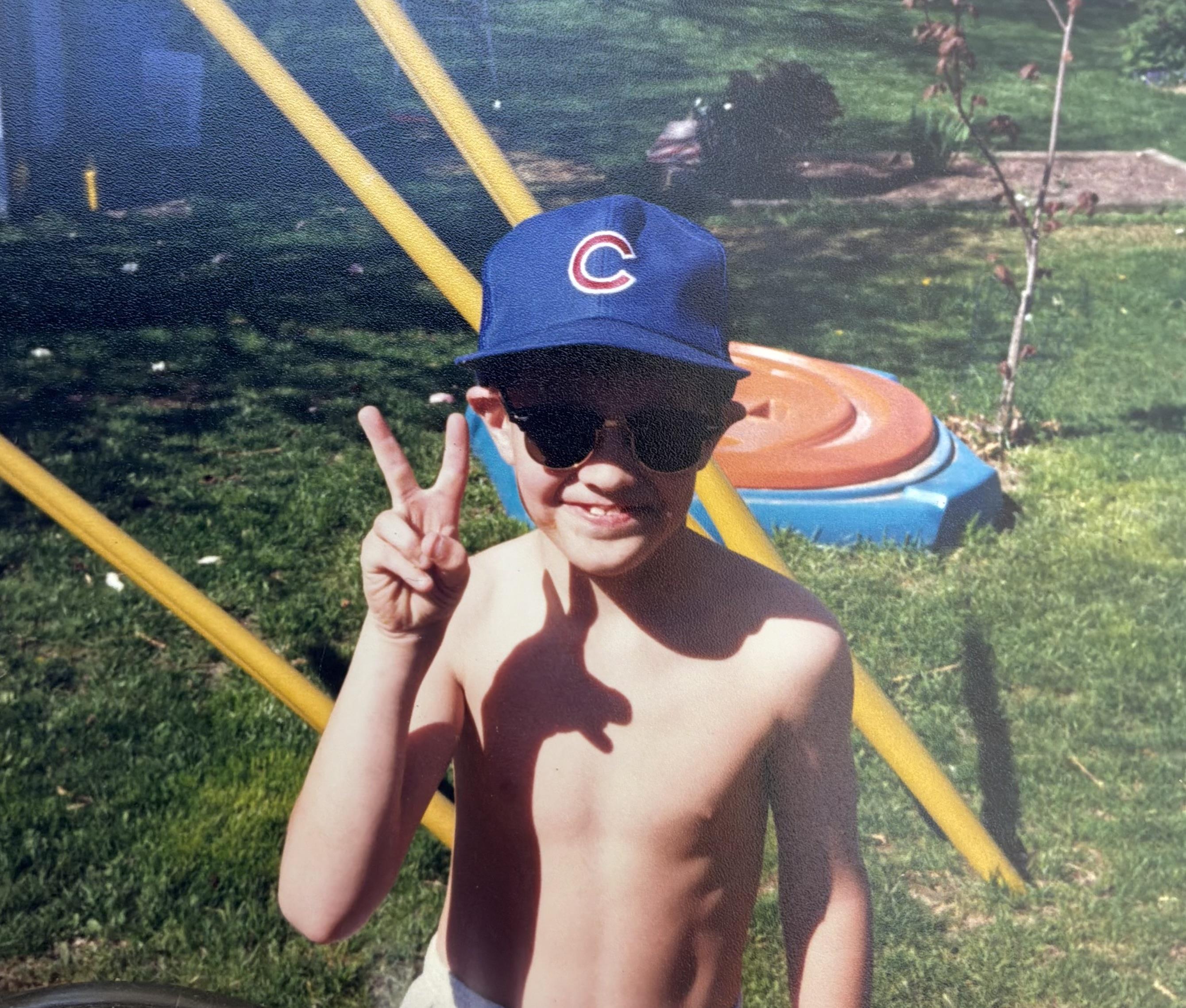 A boy wearing a hat and sunglasses