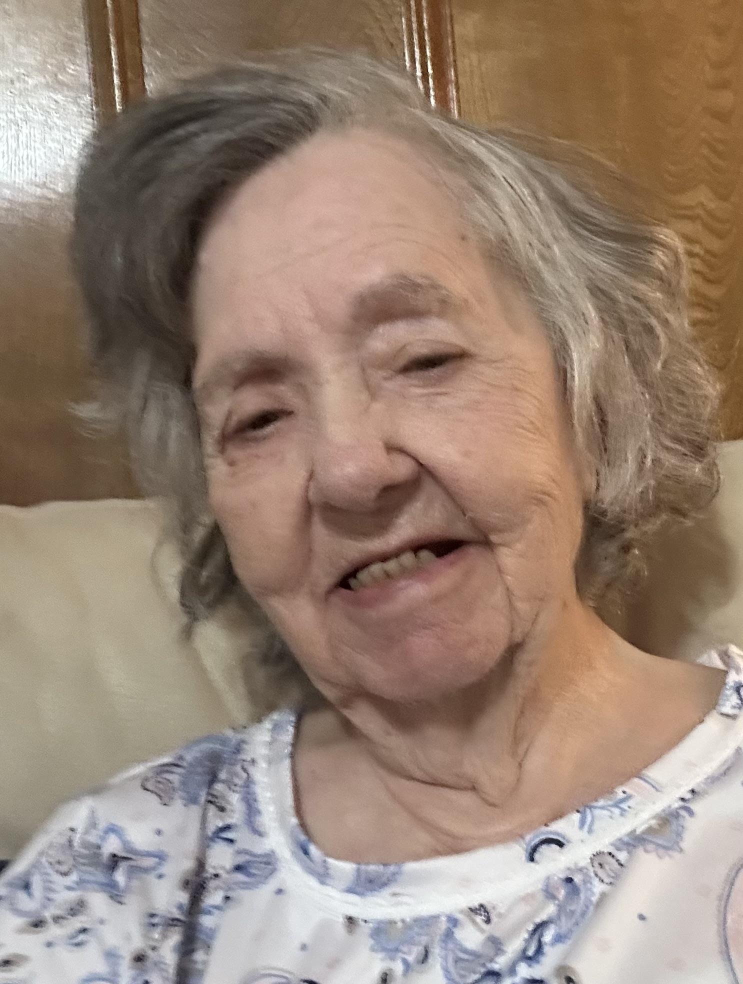 An old woman smiling for a picture