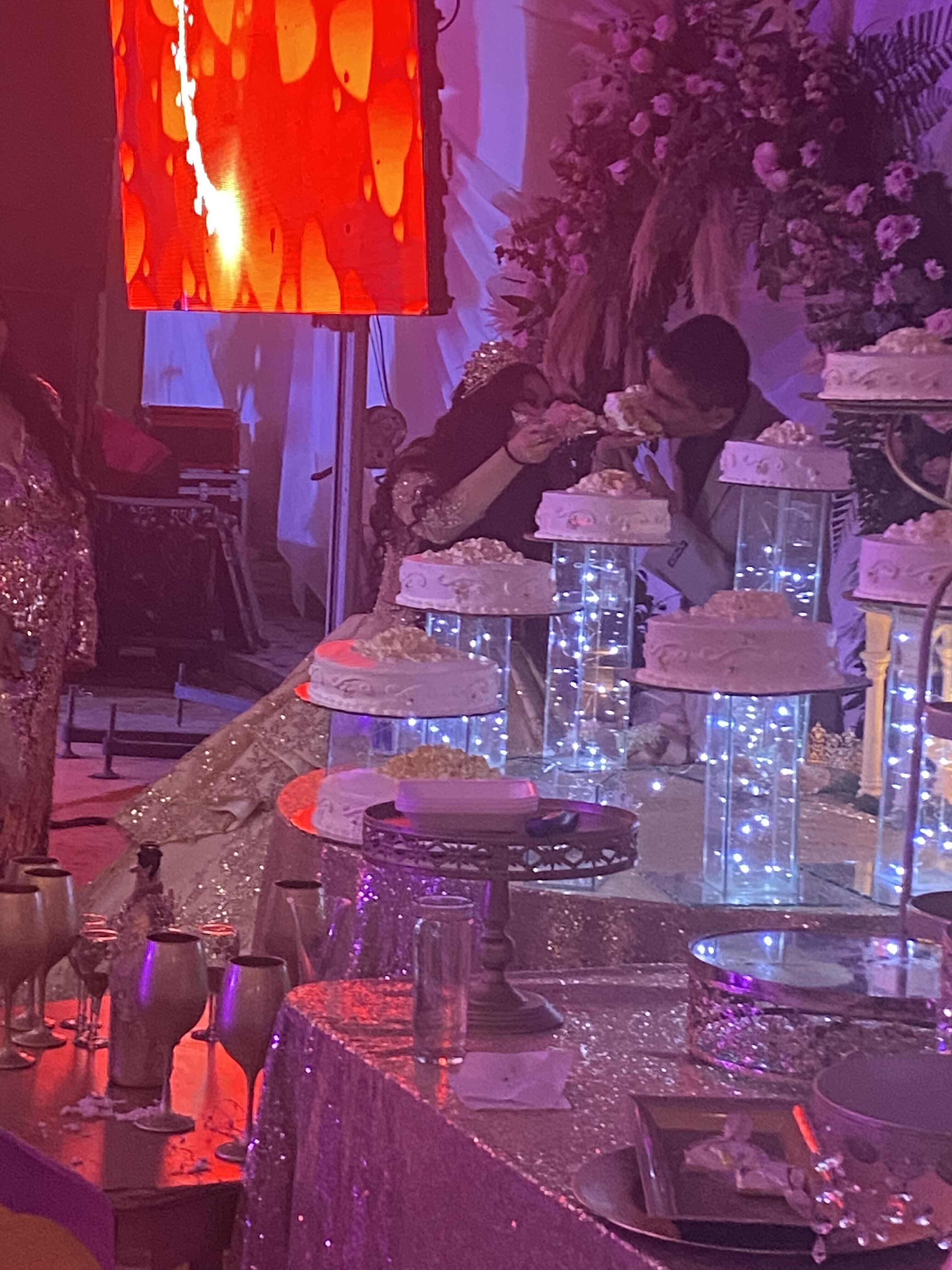 A couple eating cake on a table