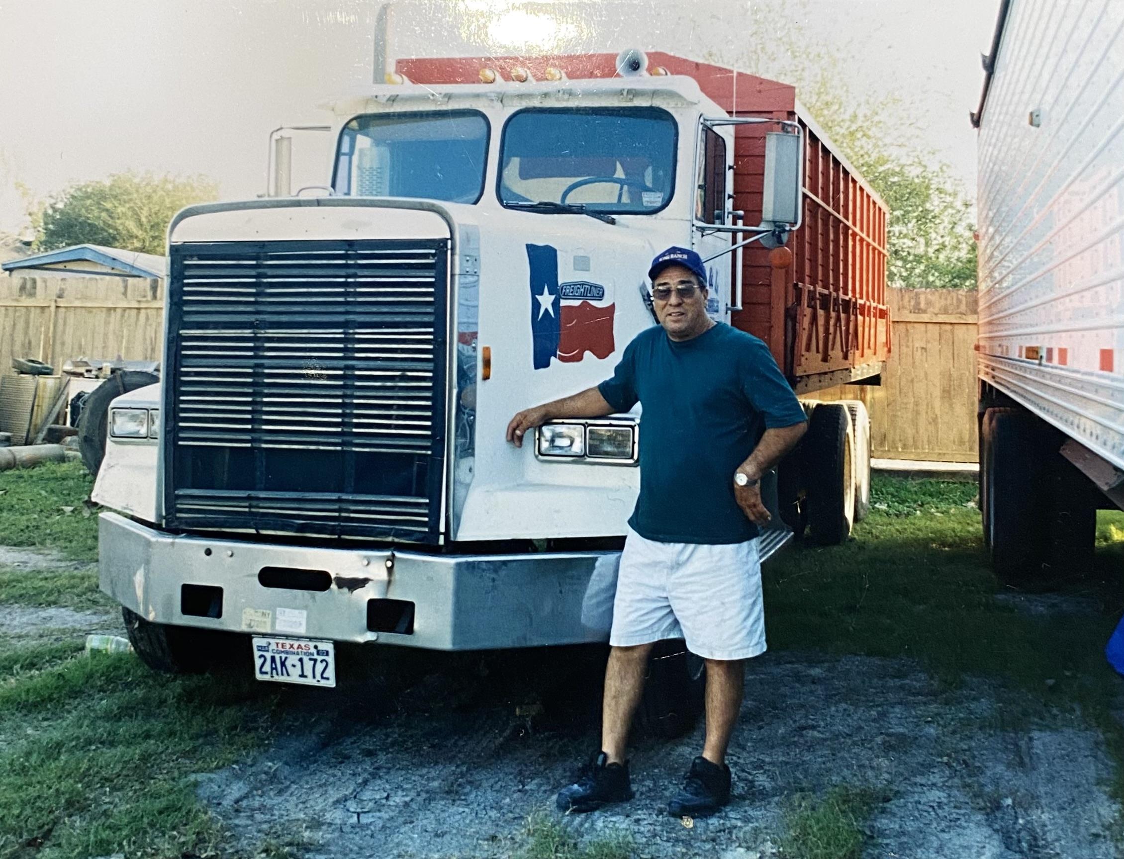 A man standing next to a truck