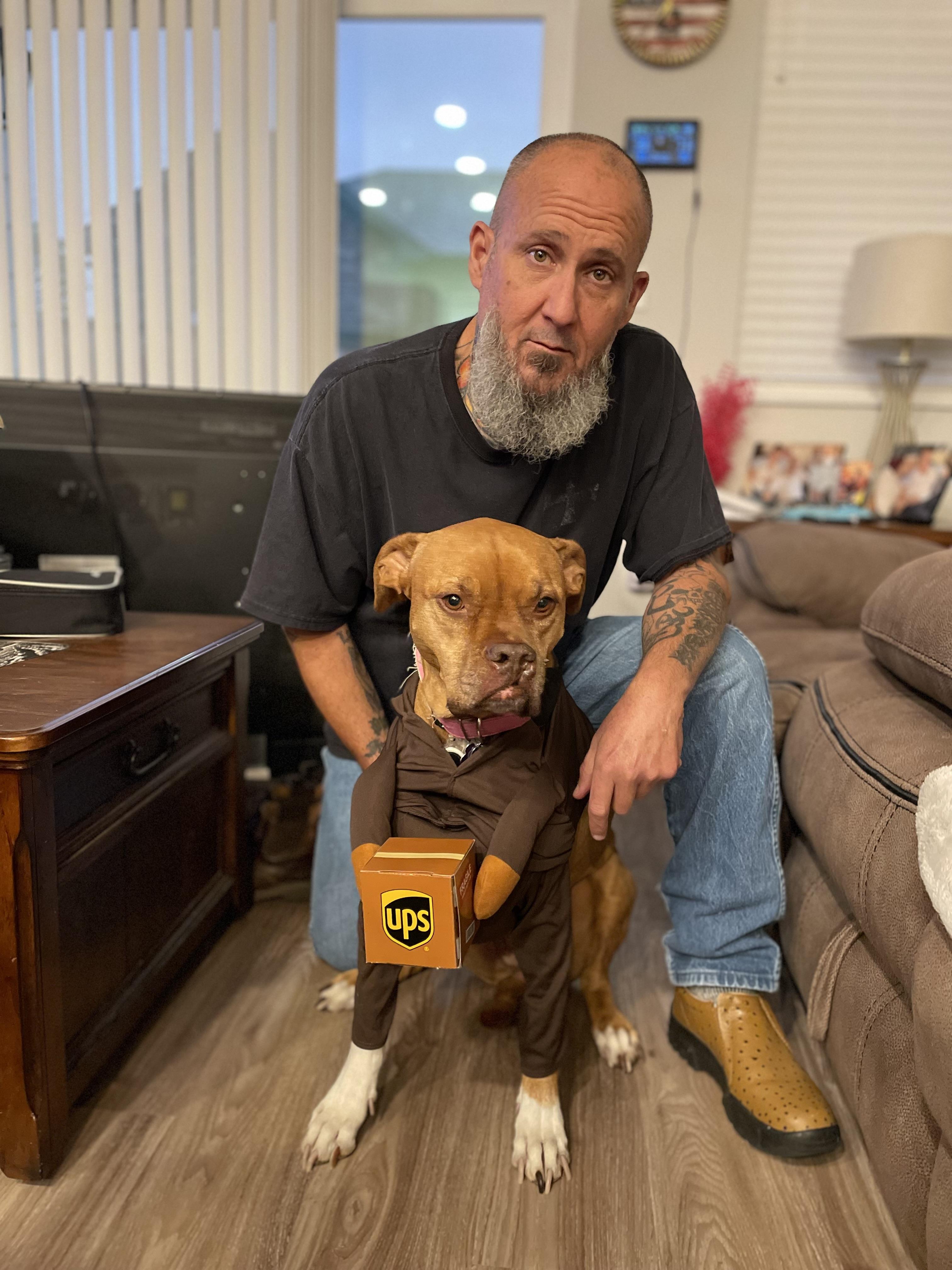 A man sitting on a couch with a dog