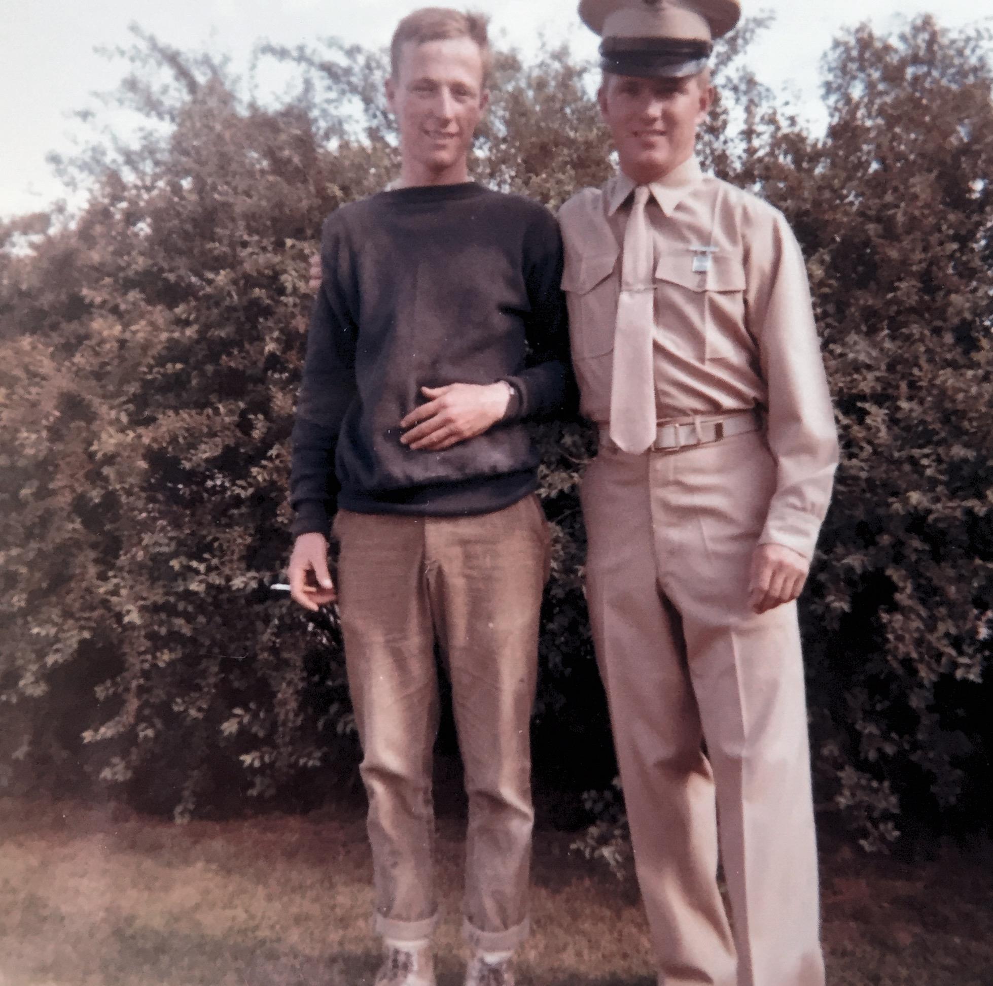 A man in uniform standing next to another man in uniform
