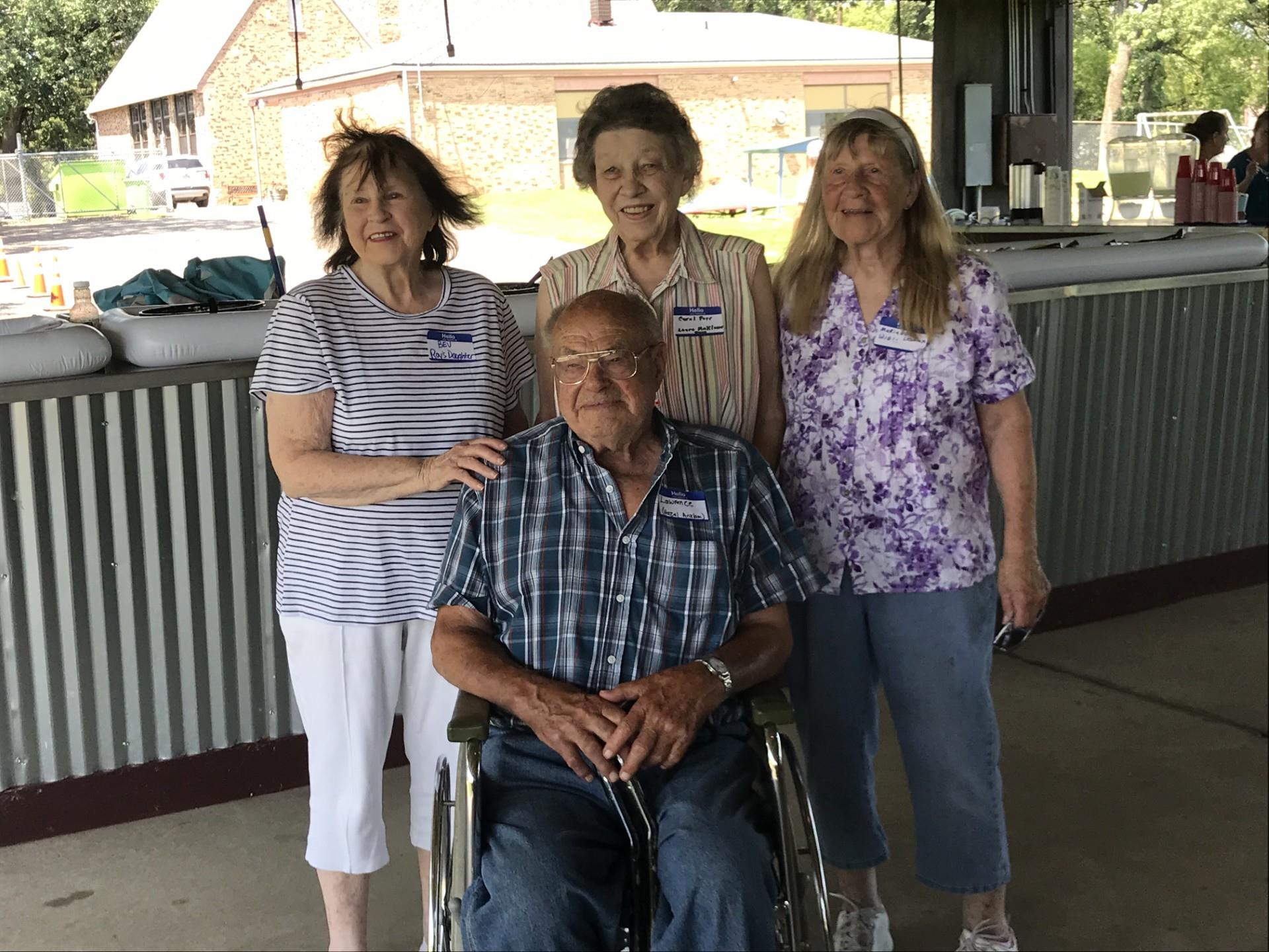 A group of older people posing for a photo