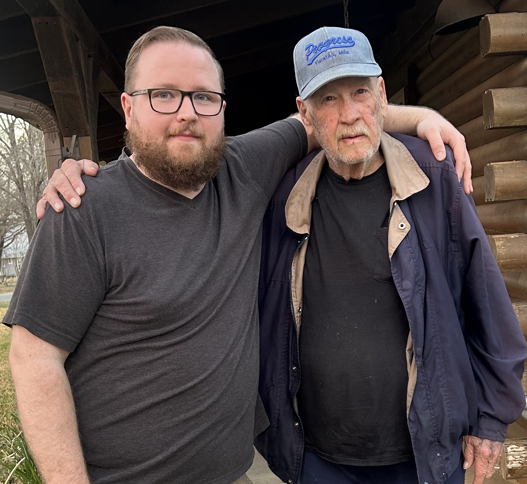 A man with his arm around another man