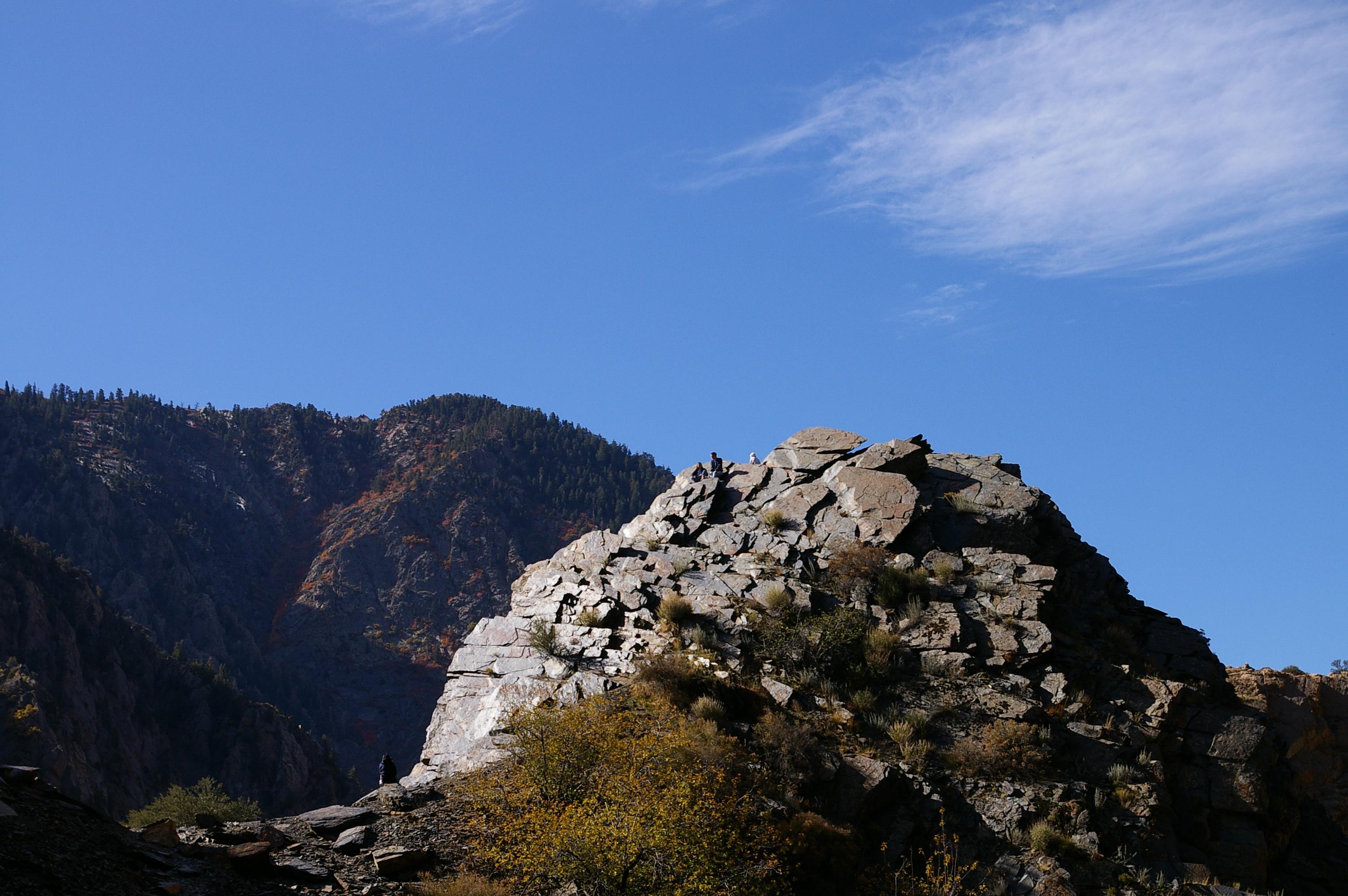 A large rock formation with a mountain in the background