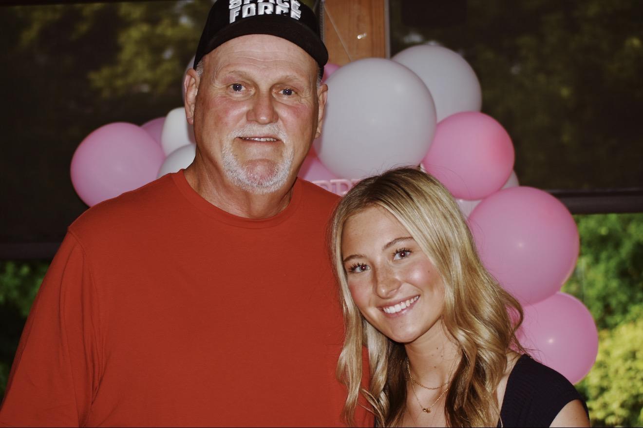 A man and woman standing in front of balloons