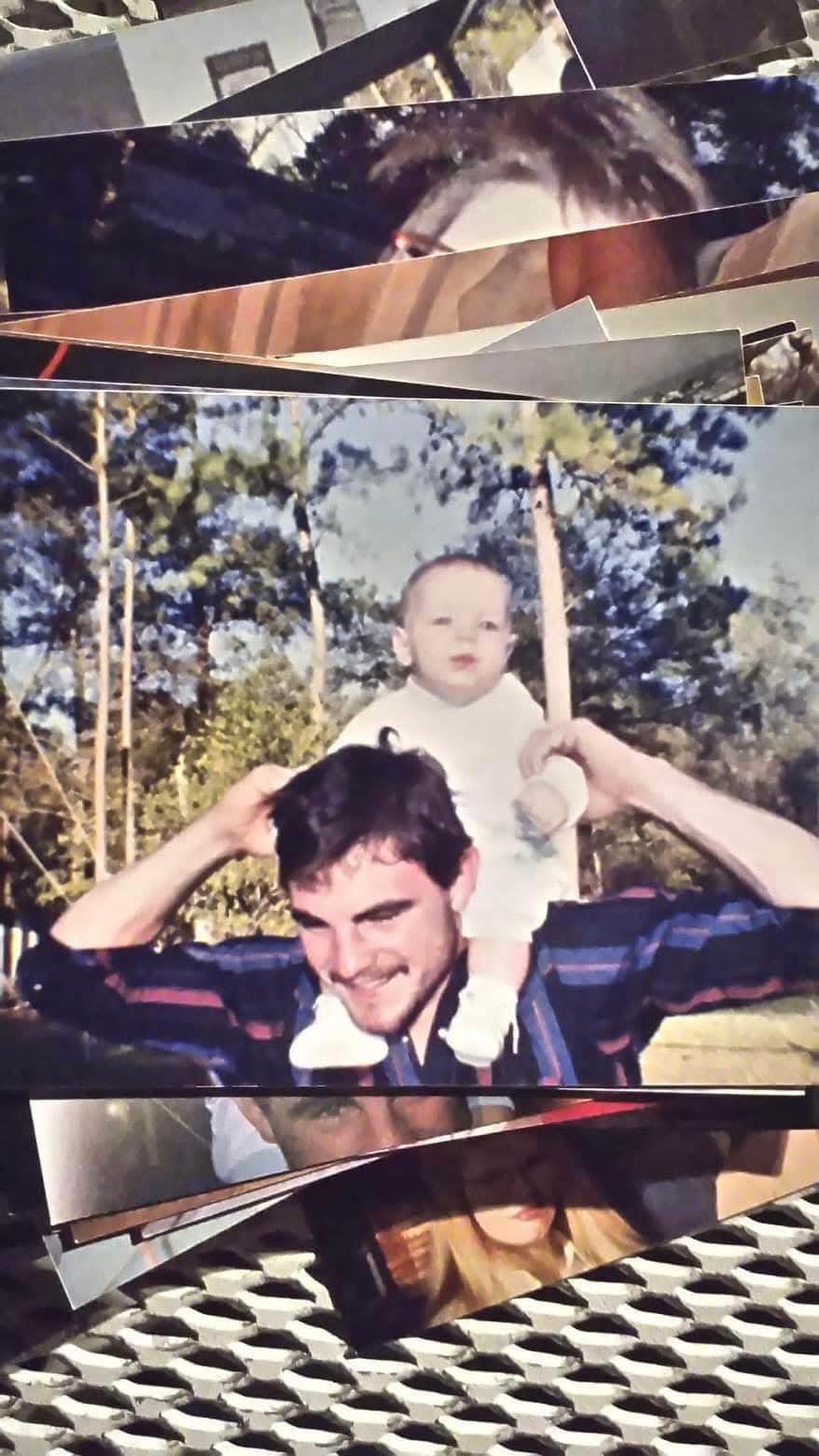 A man holding a baby on his shoulders