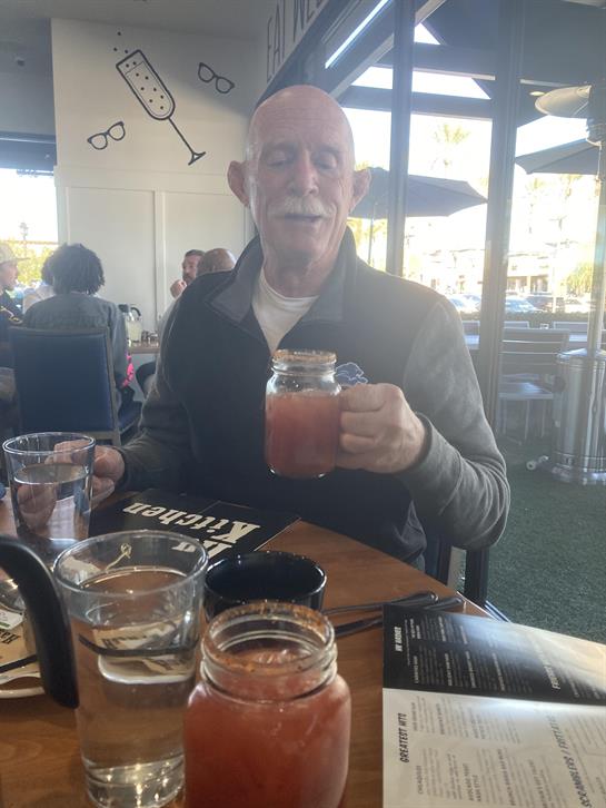 A man holding a jar of liquid