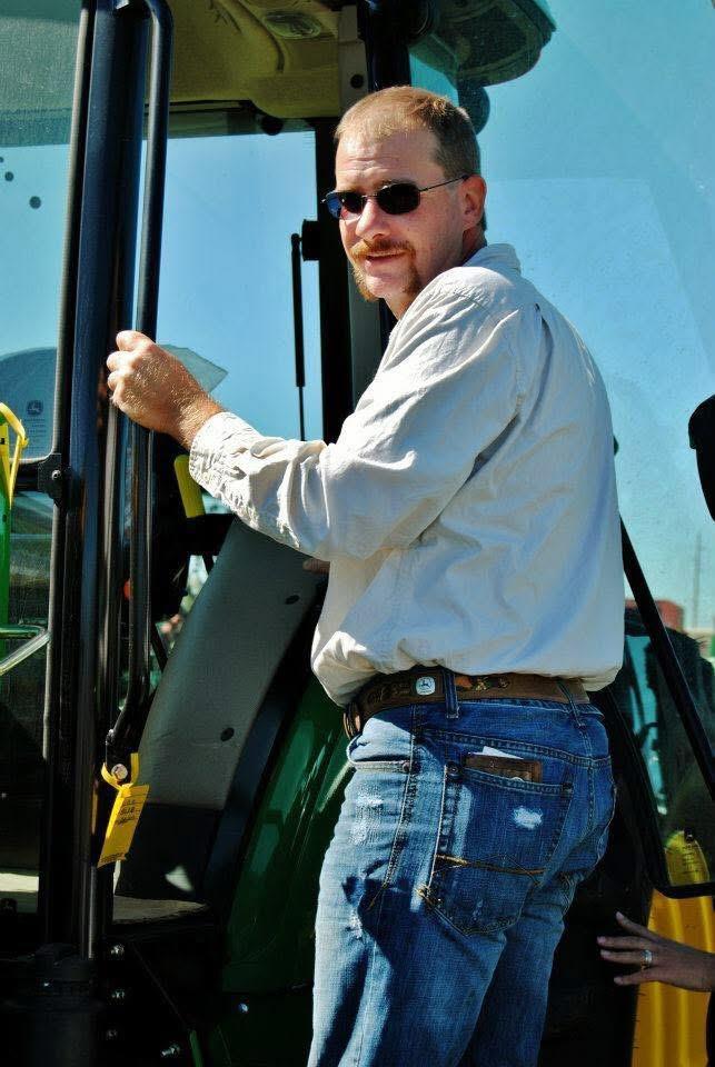 A man in sunglasses and a white shirt