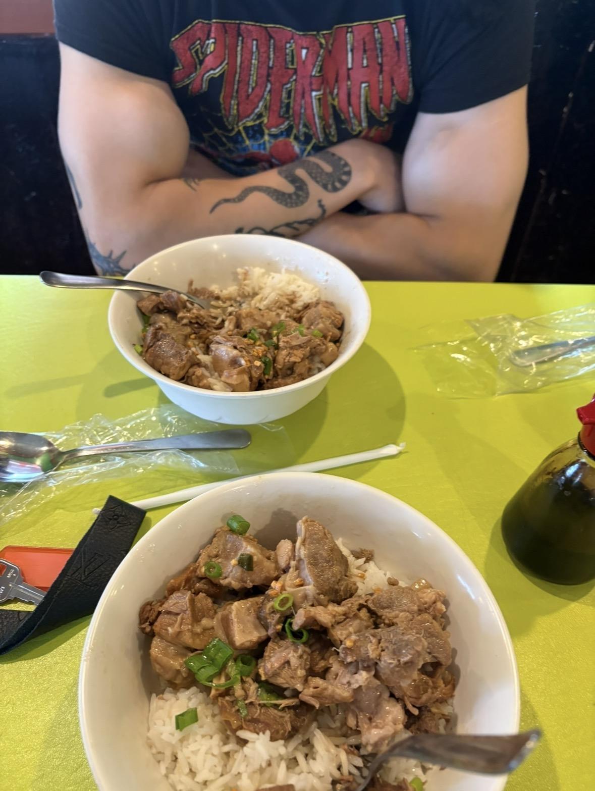 A man sitting at a table with bowls of food