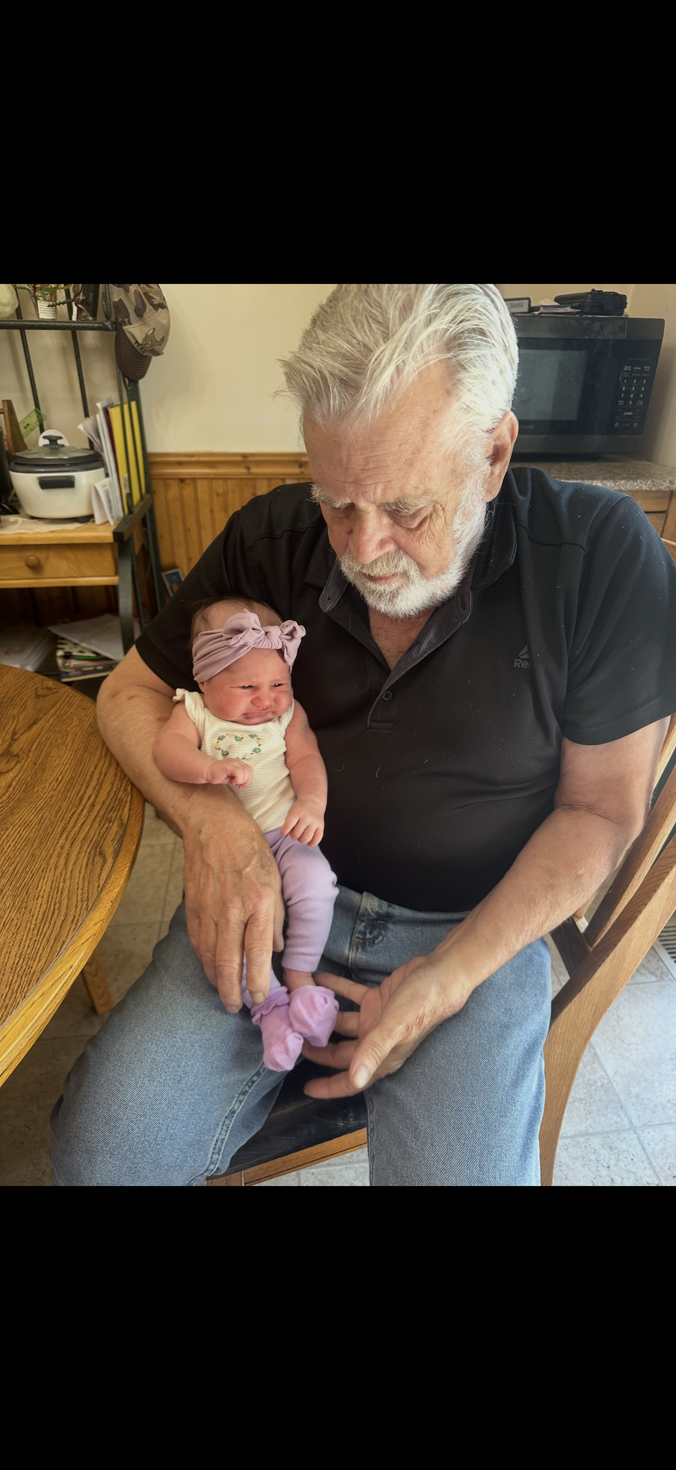 An old man holding a baby