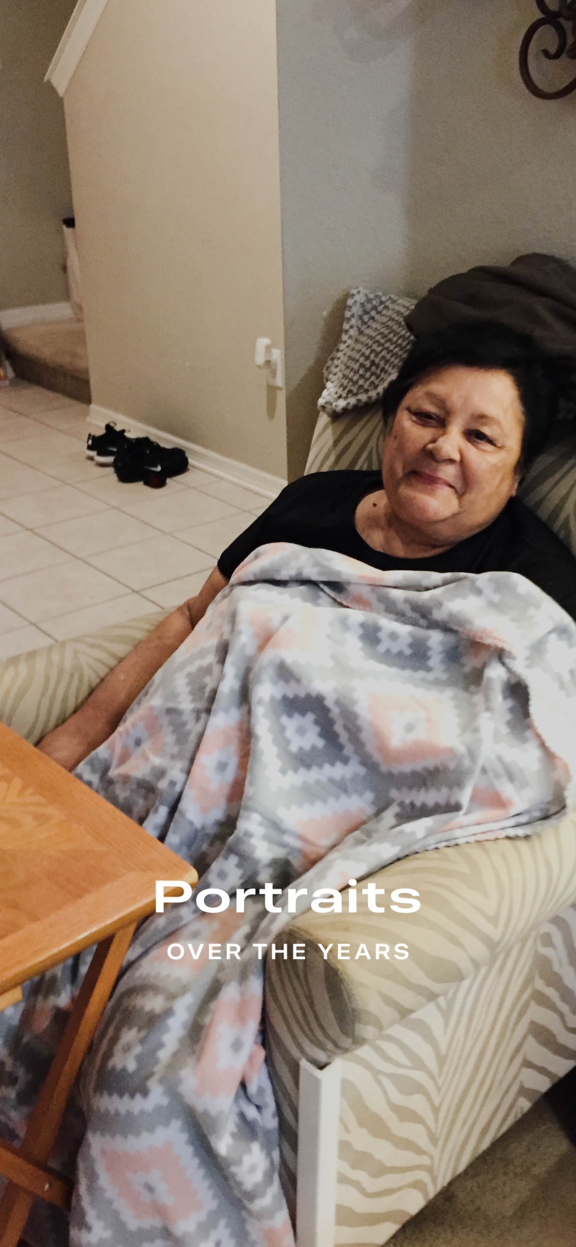 A woman sitting on a couch with a blanket
