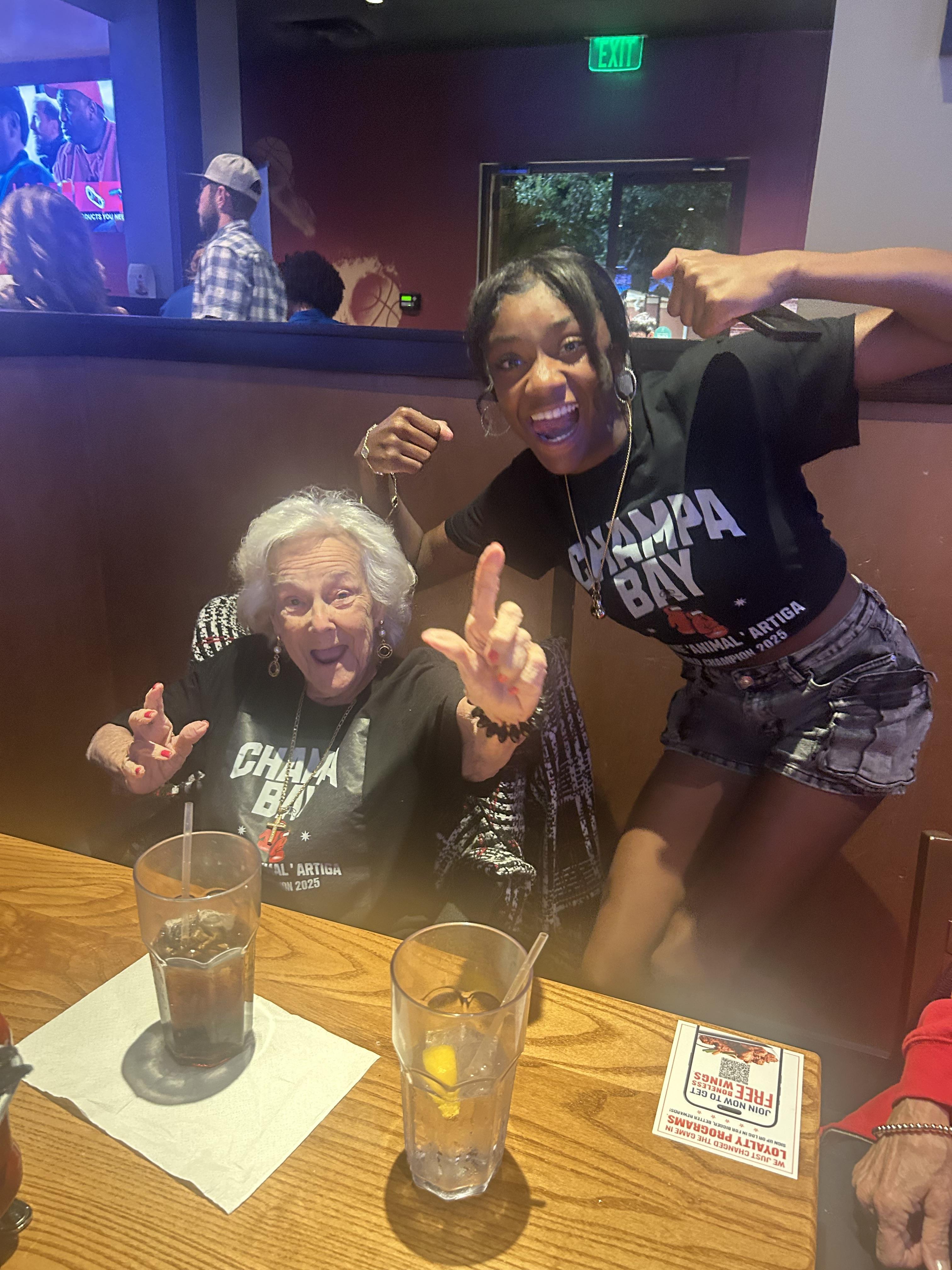 A woman posing for a picture with a woman