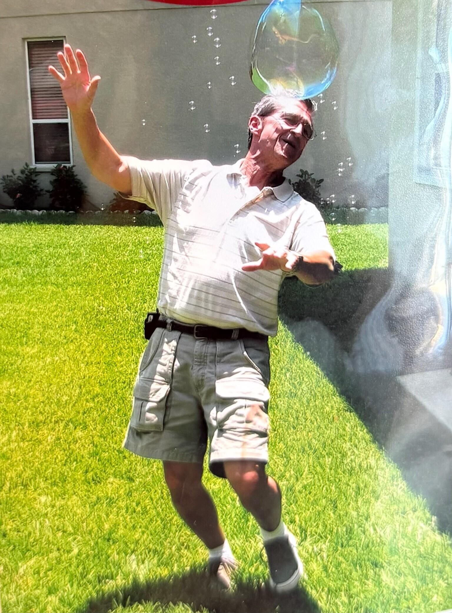 A man throwing bubbles in the air