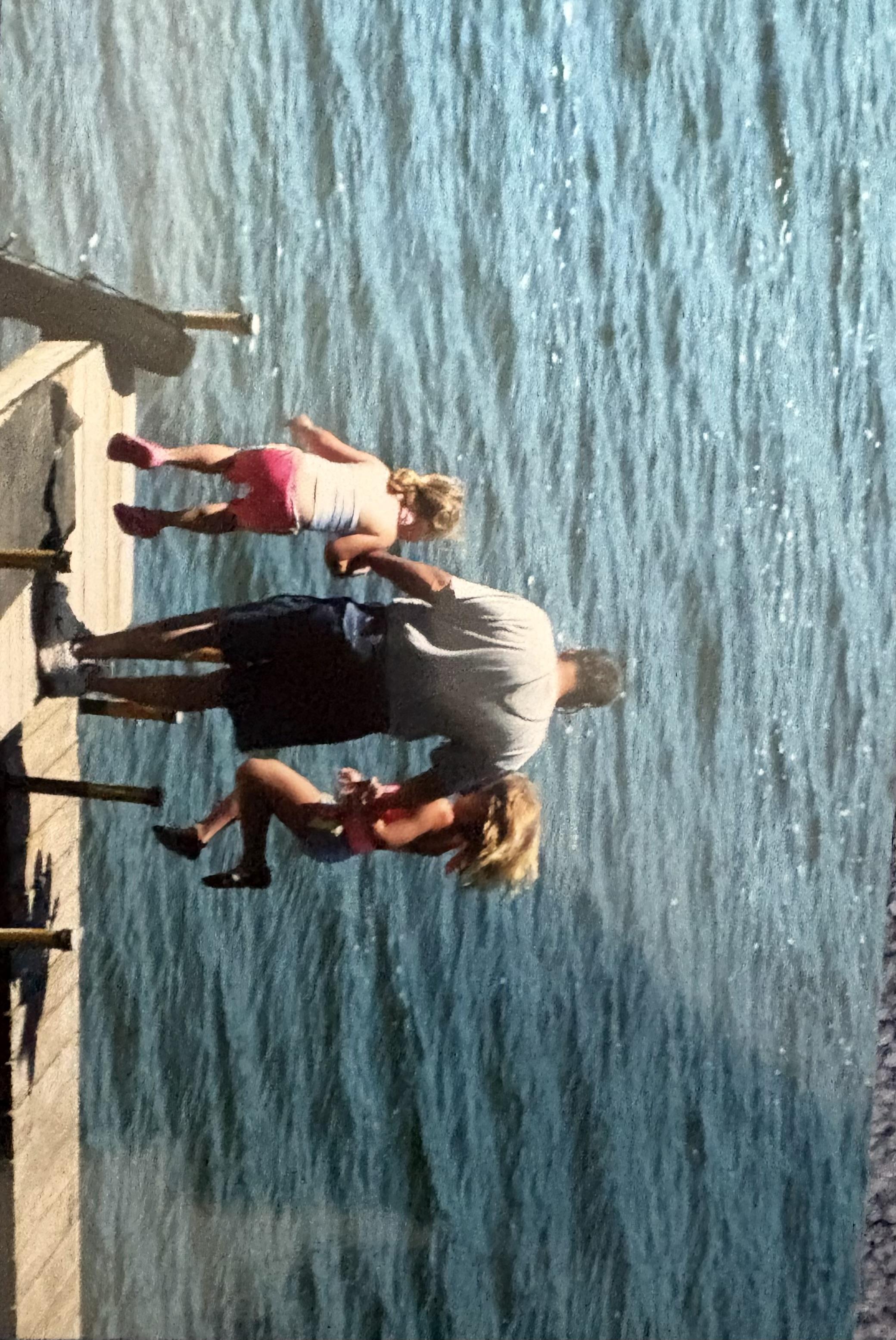A man and woman on a dock with two children