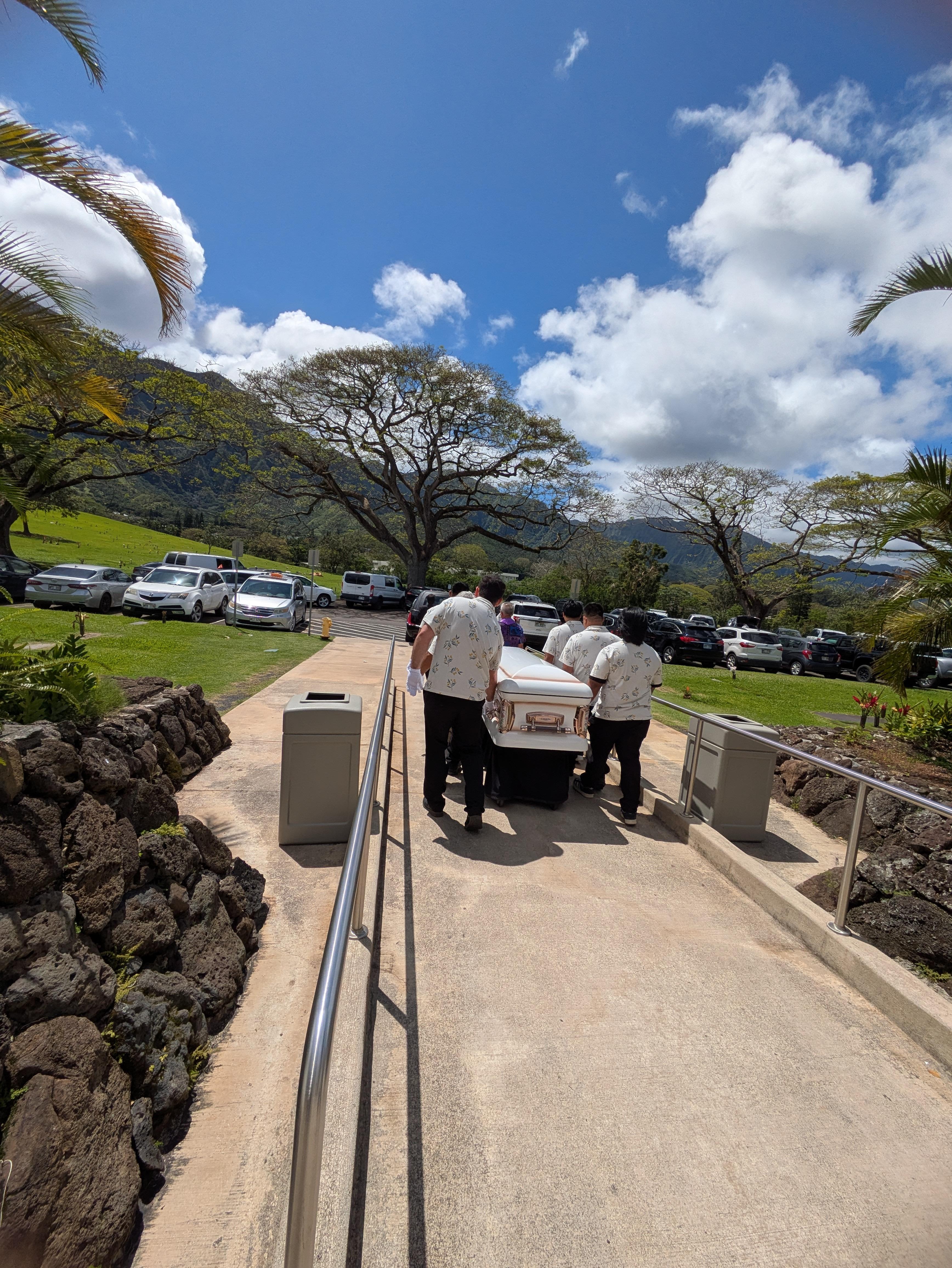 A group of people carrying a white casket