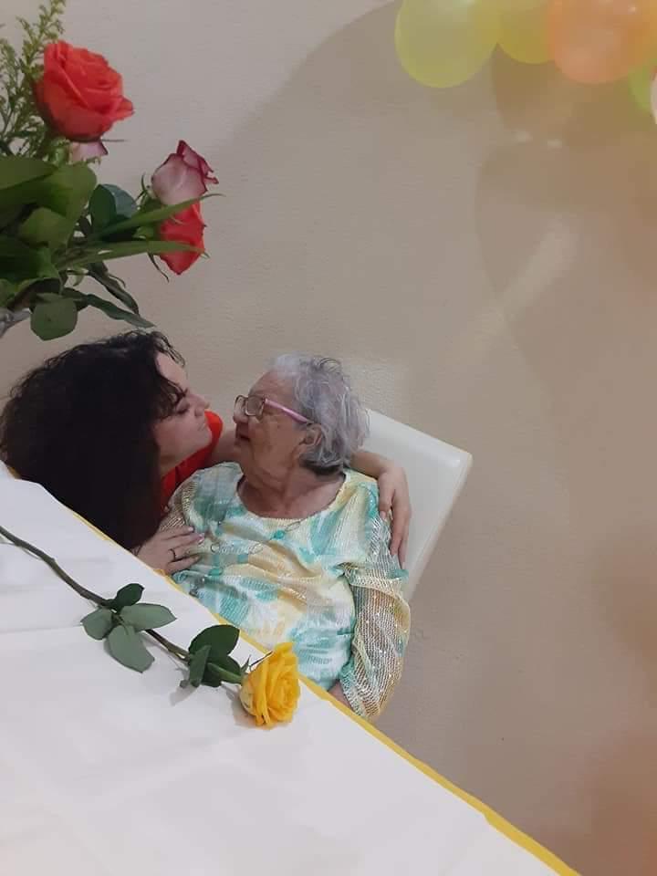 A woman kissing an old woman