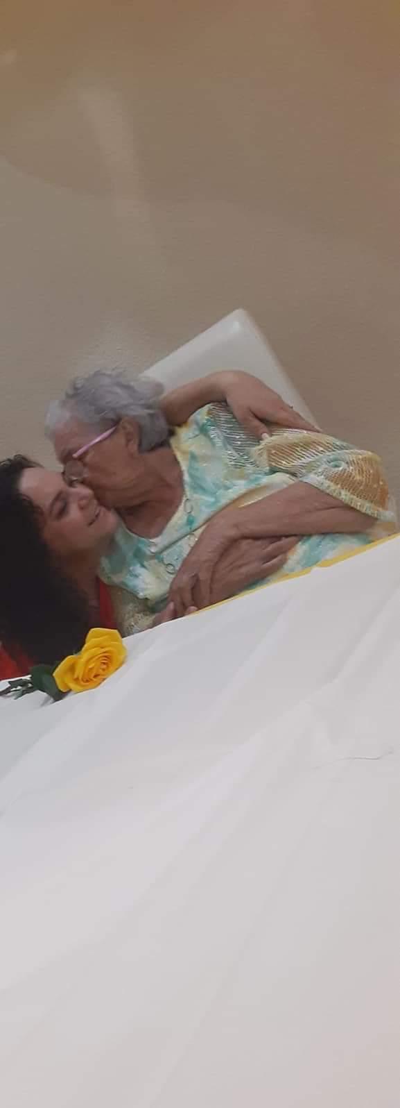 A woman kissing an older woman