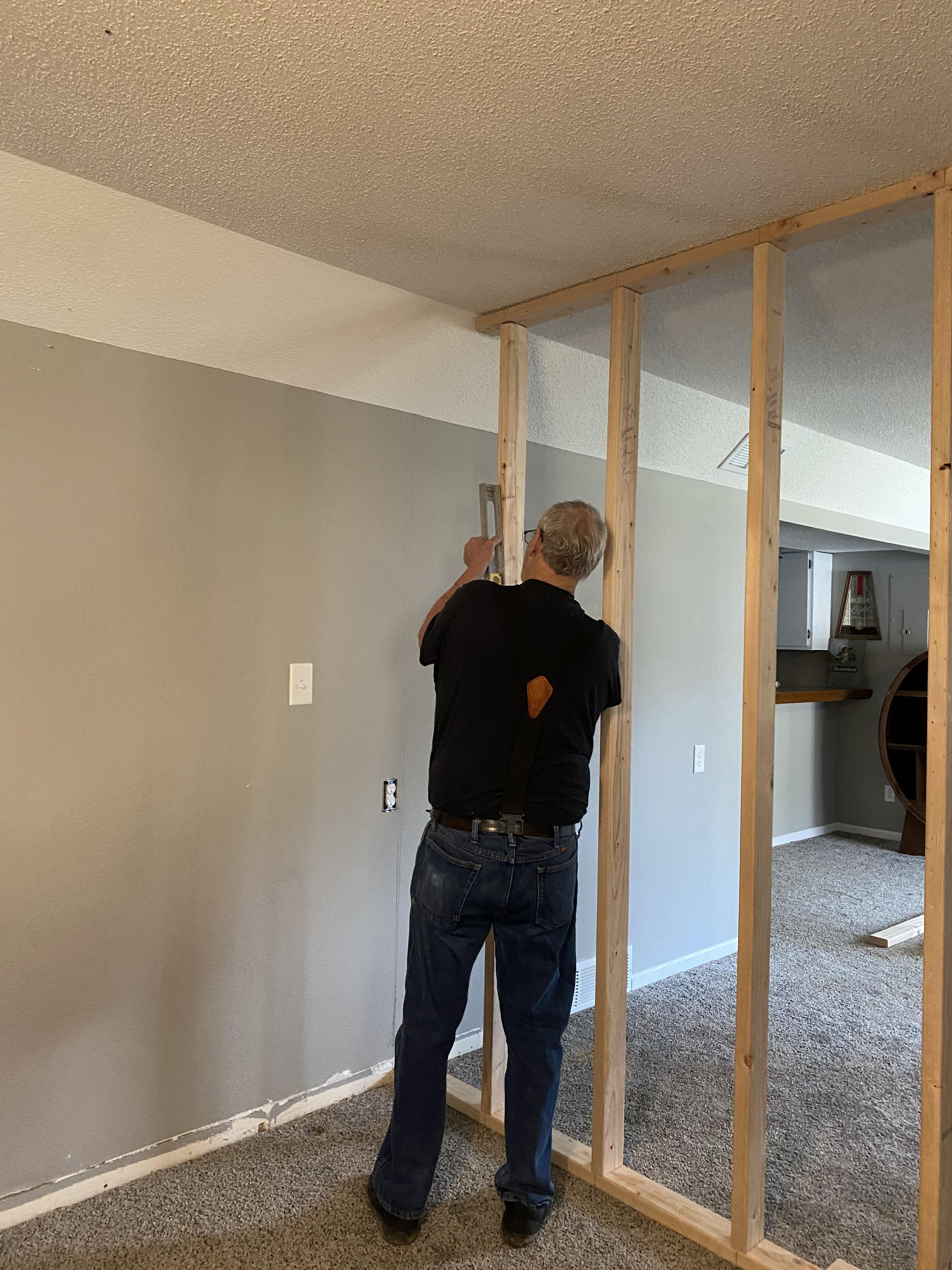 A man in a room with a wall