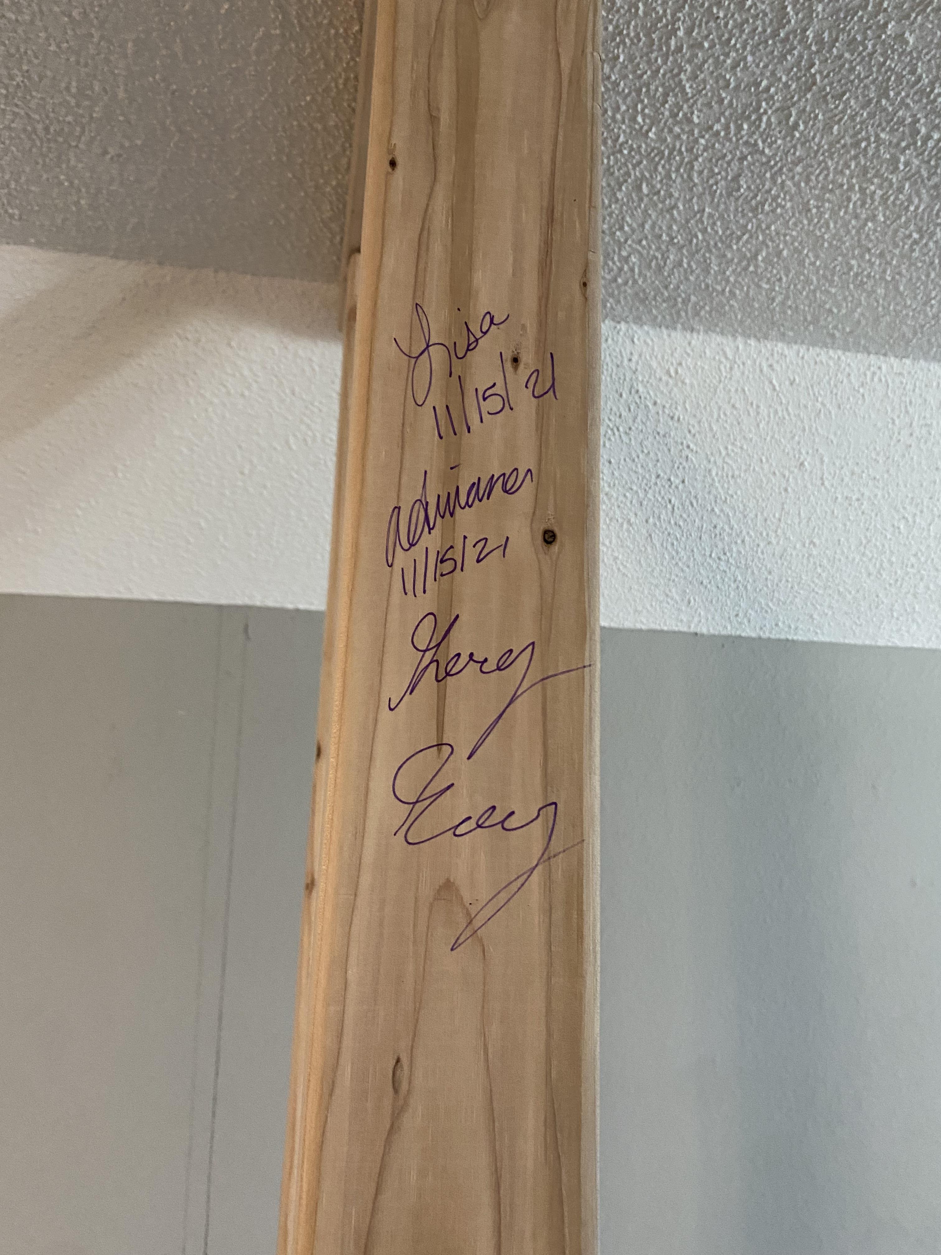 A wood beam with writing on it