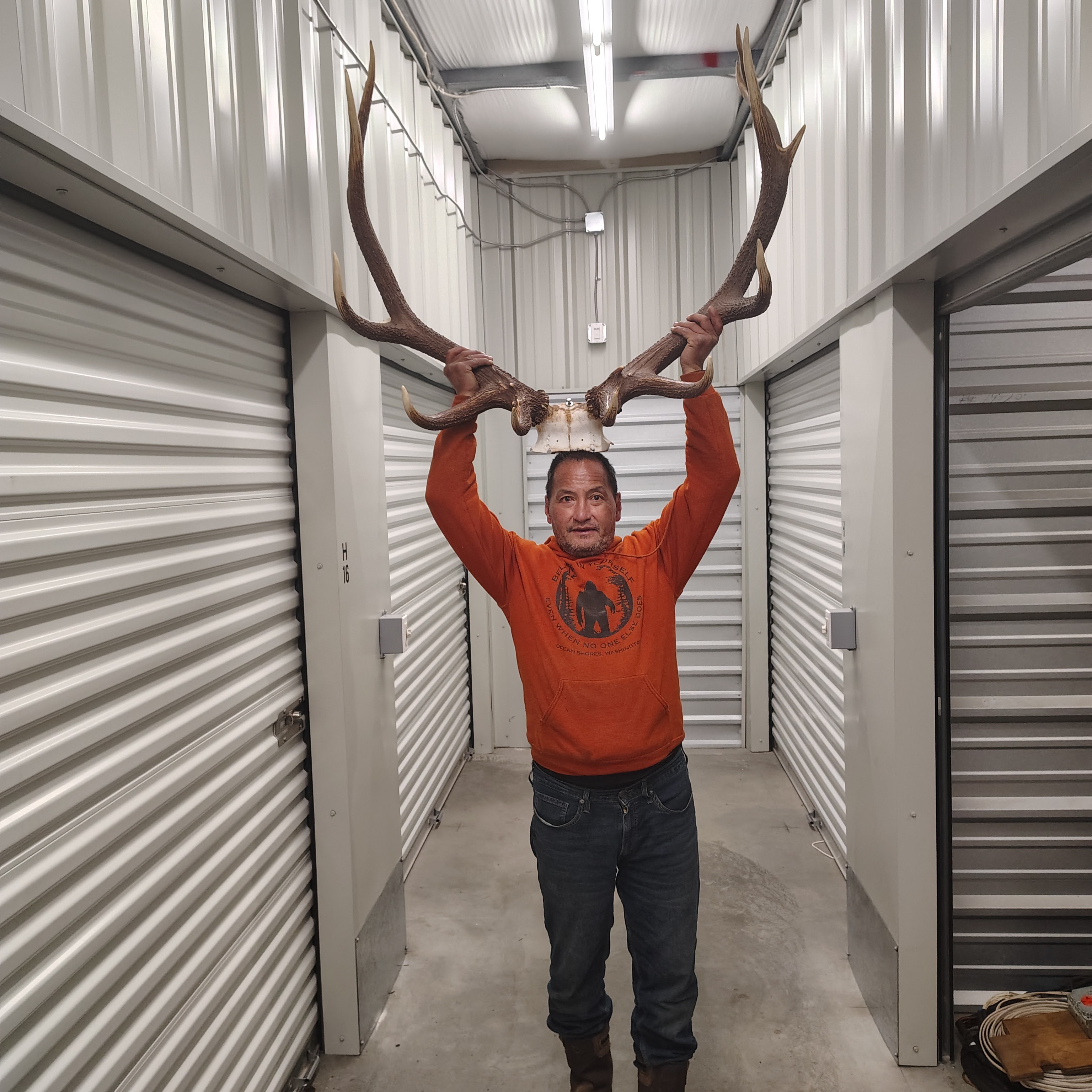 A man holding antlers over his head