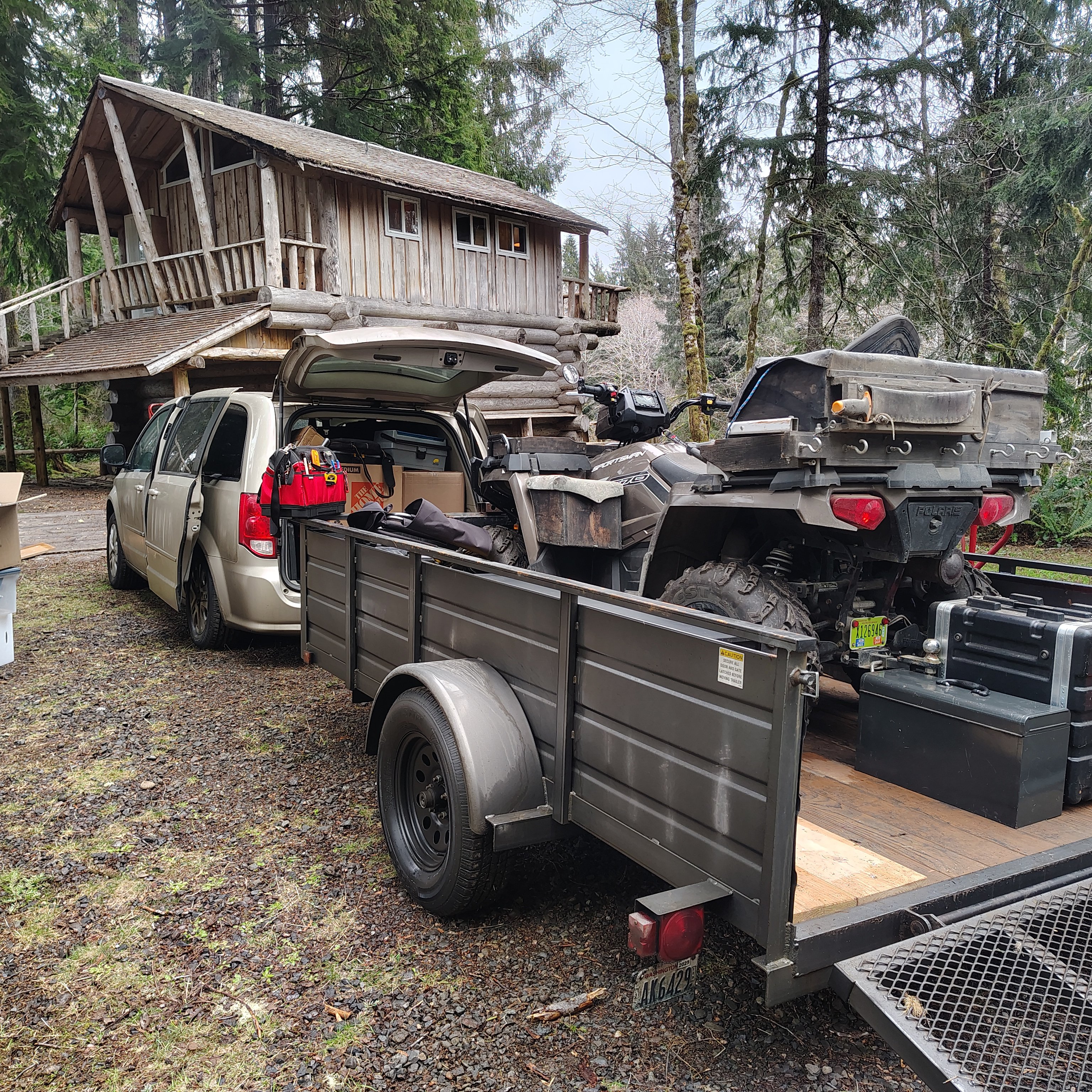 A vehicle with a trailer in the back of it