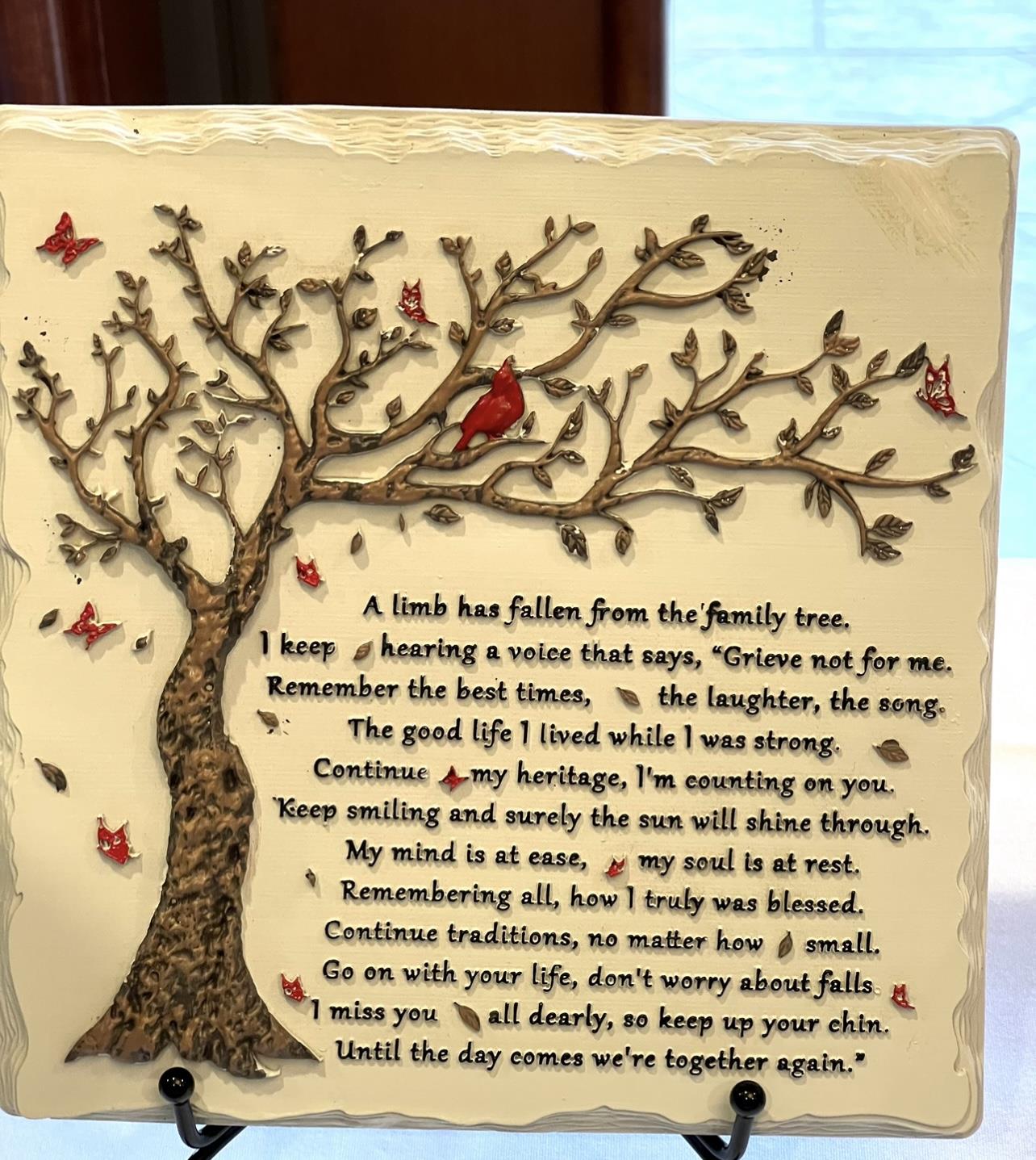 A plaque with a tree and birds
