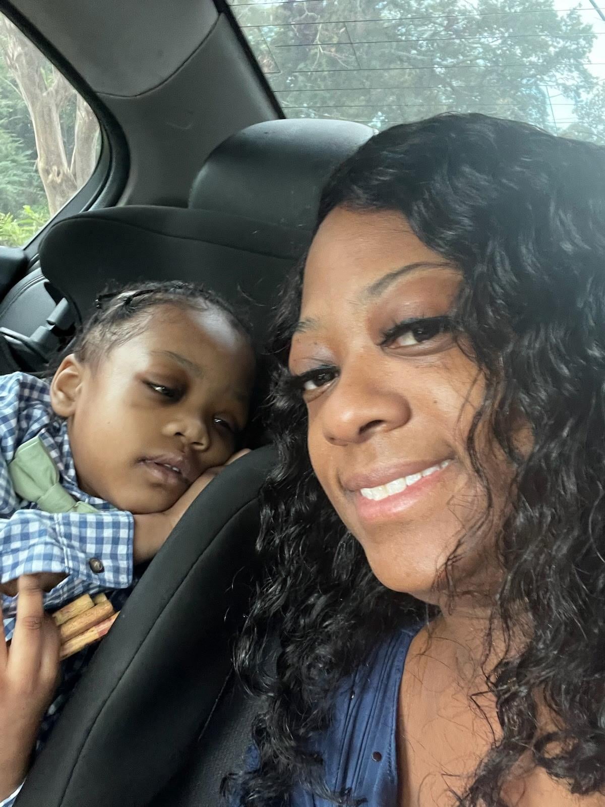 A woman and child in a car