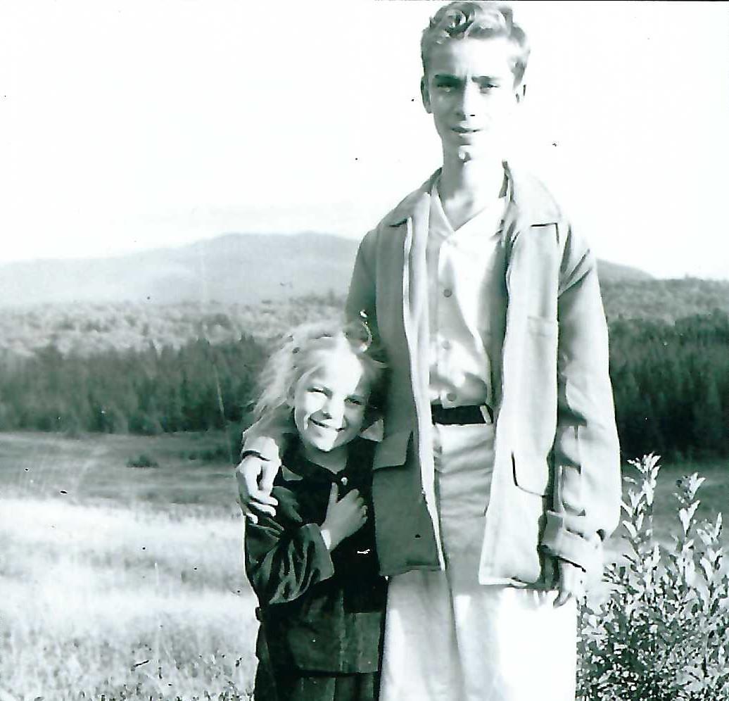 A boy and girl posing for a picture