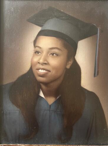A woman in a graduation cap and gown
