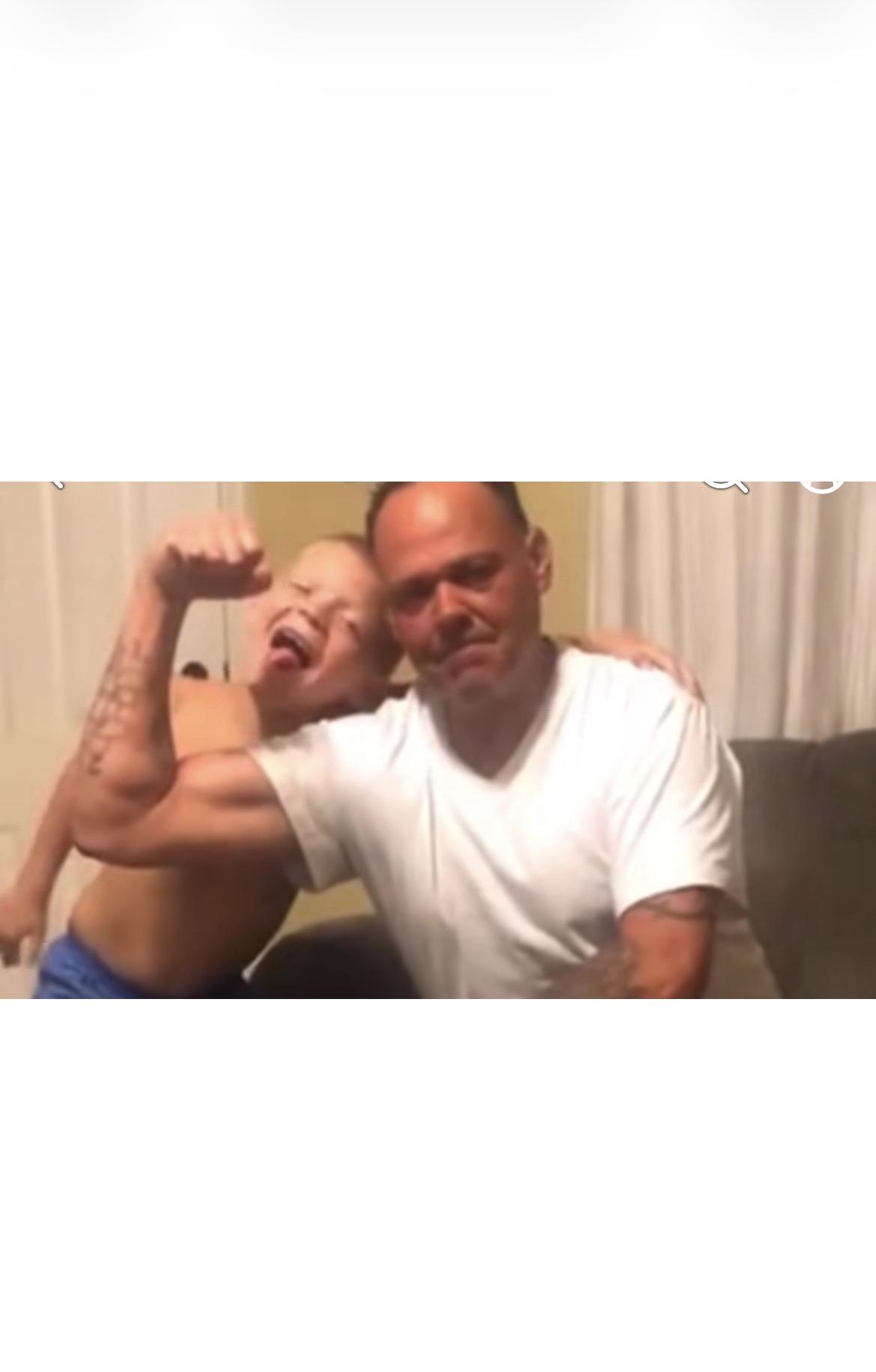 A man and boy flexing their arms