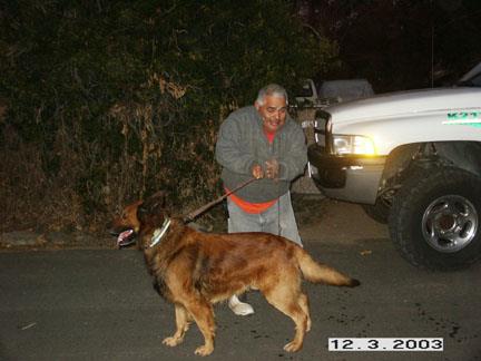 A man standing next to a dog