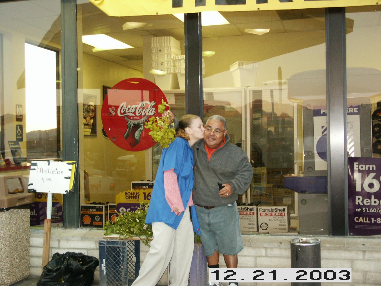 A man and woman standing in front of a store