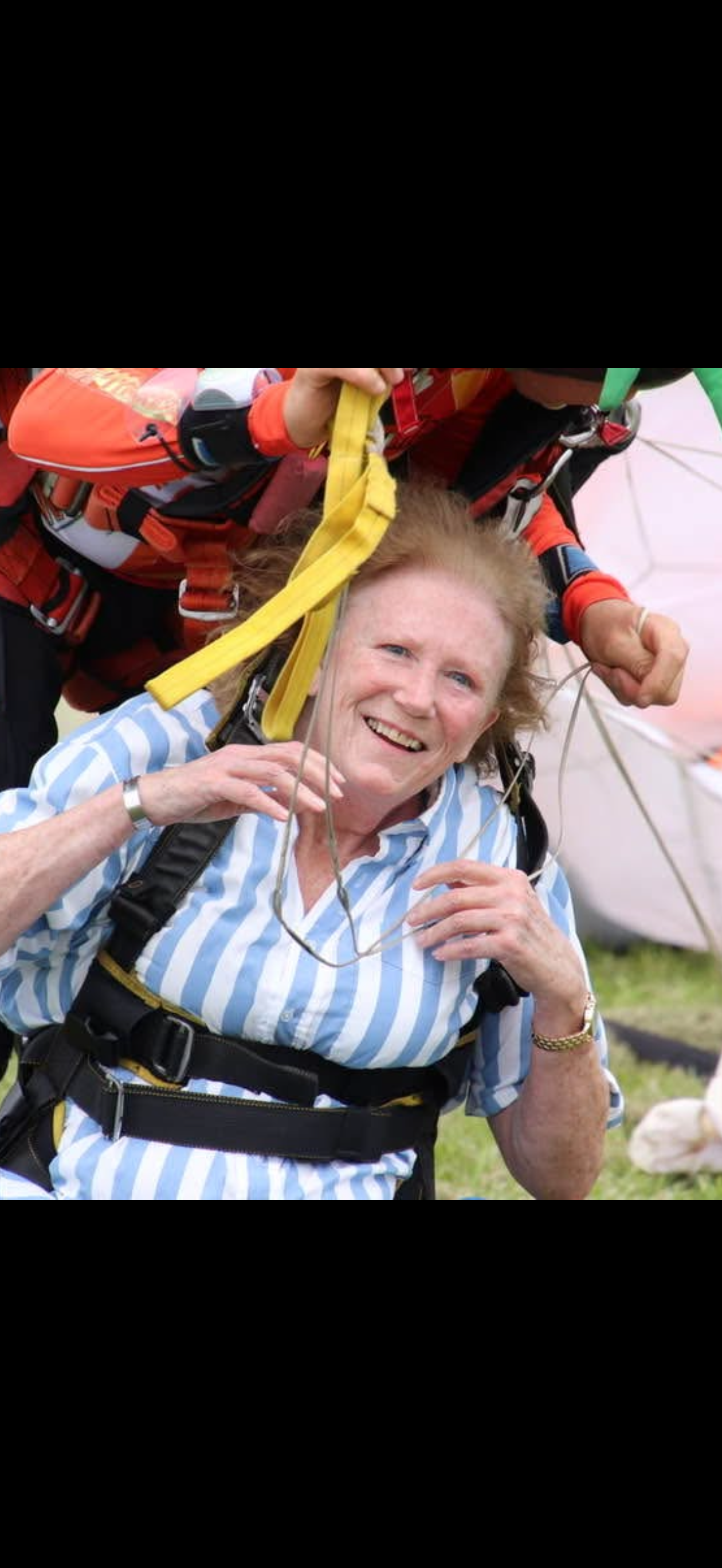 A woman being carried by a parachutist