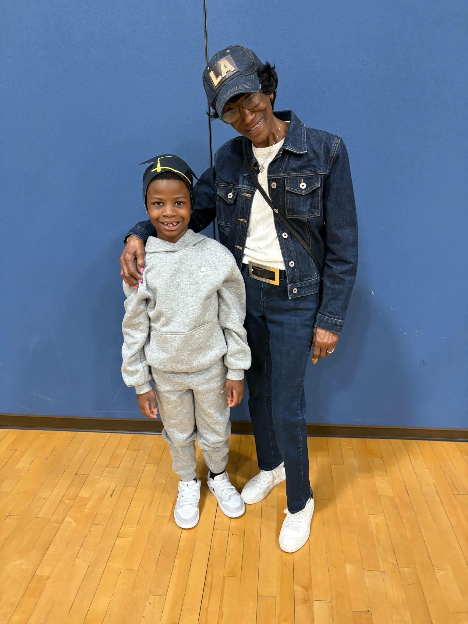 A woman and a boy posing for a picture