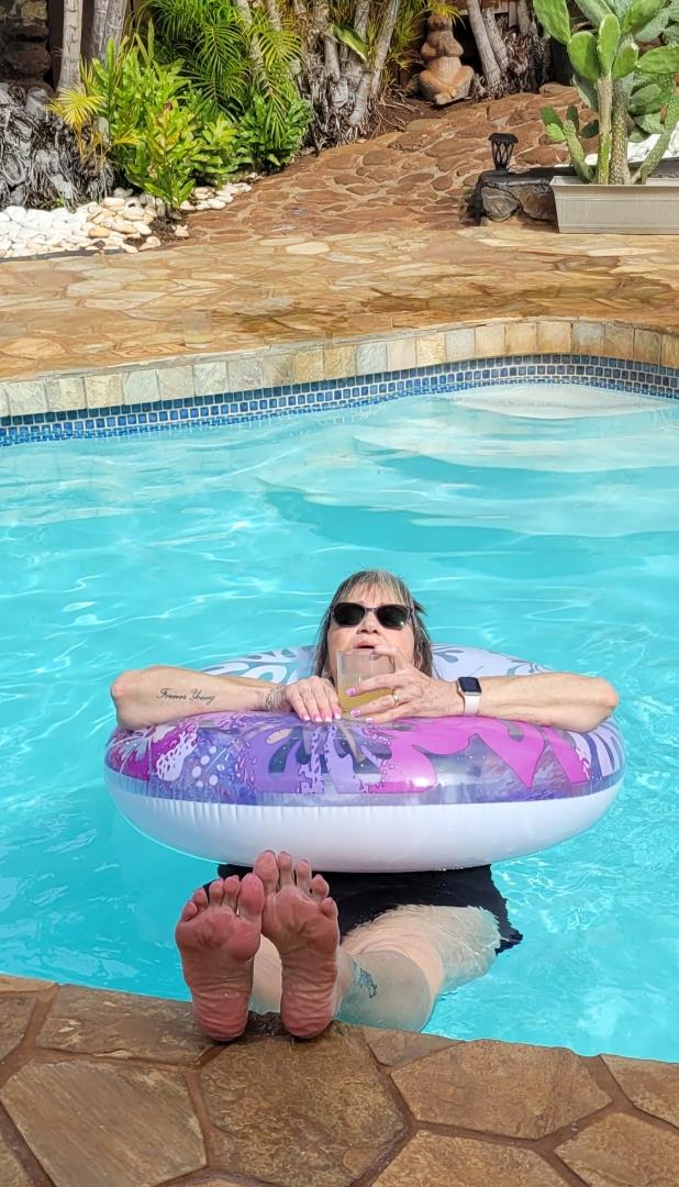 A person in a pool with a float