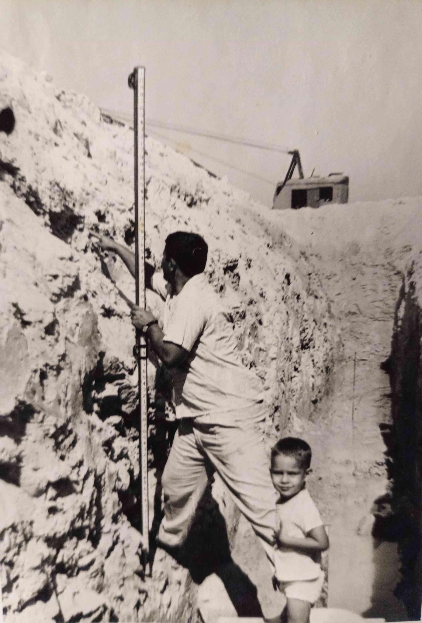 A man and child standing on a rock wall