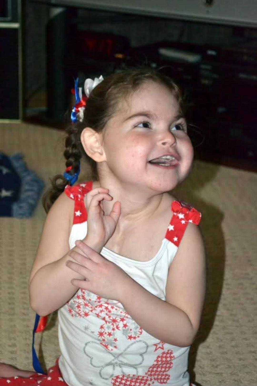 A girl with a red white and blue bow on her head