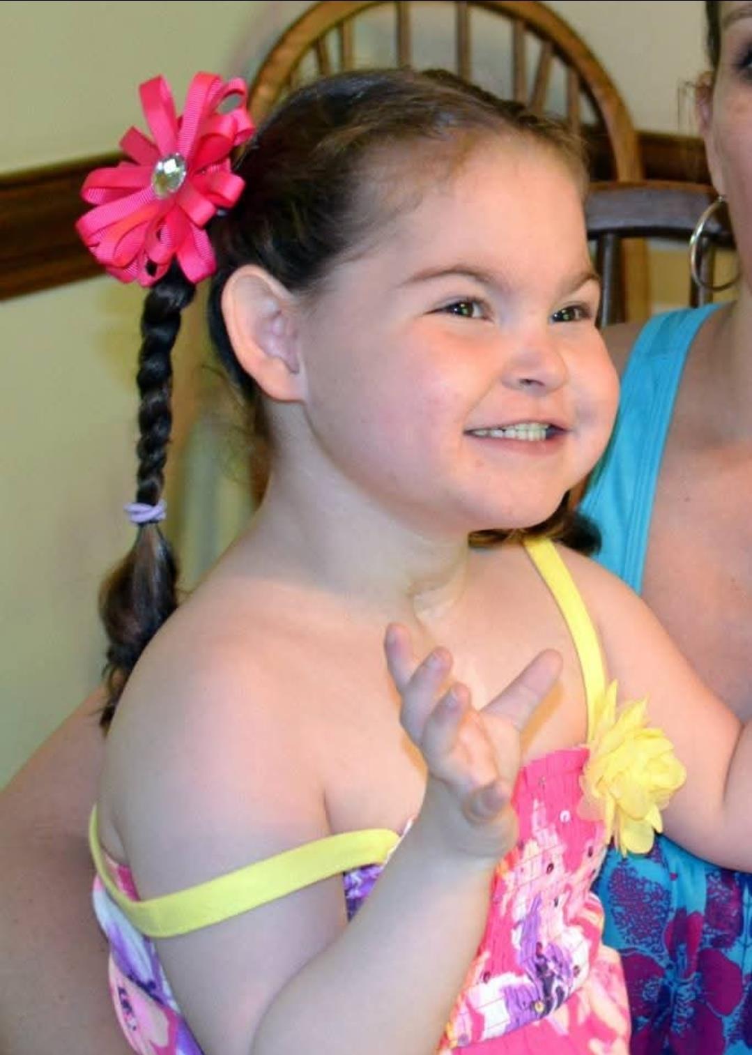 A girl with pigtails and a flower in her hair