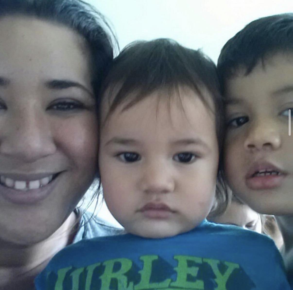 A woman and two children posing for a selfie