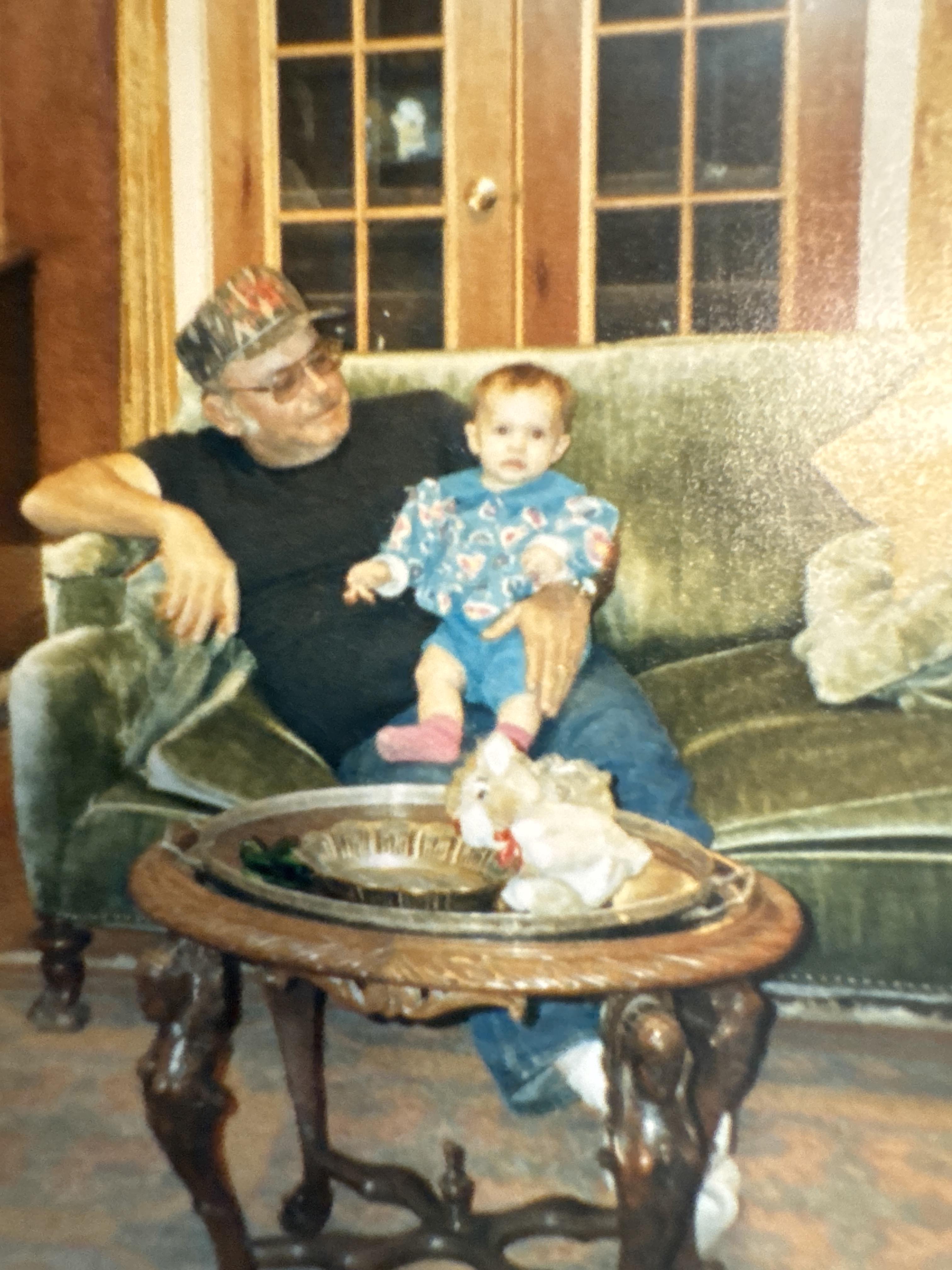 A man sitting on a couch with a baby