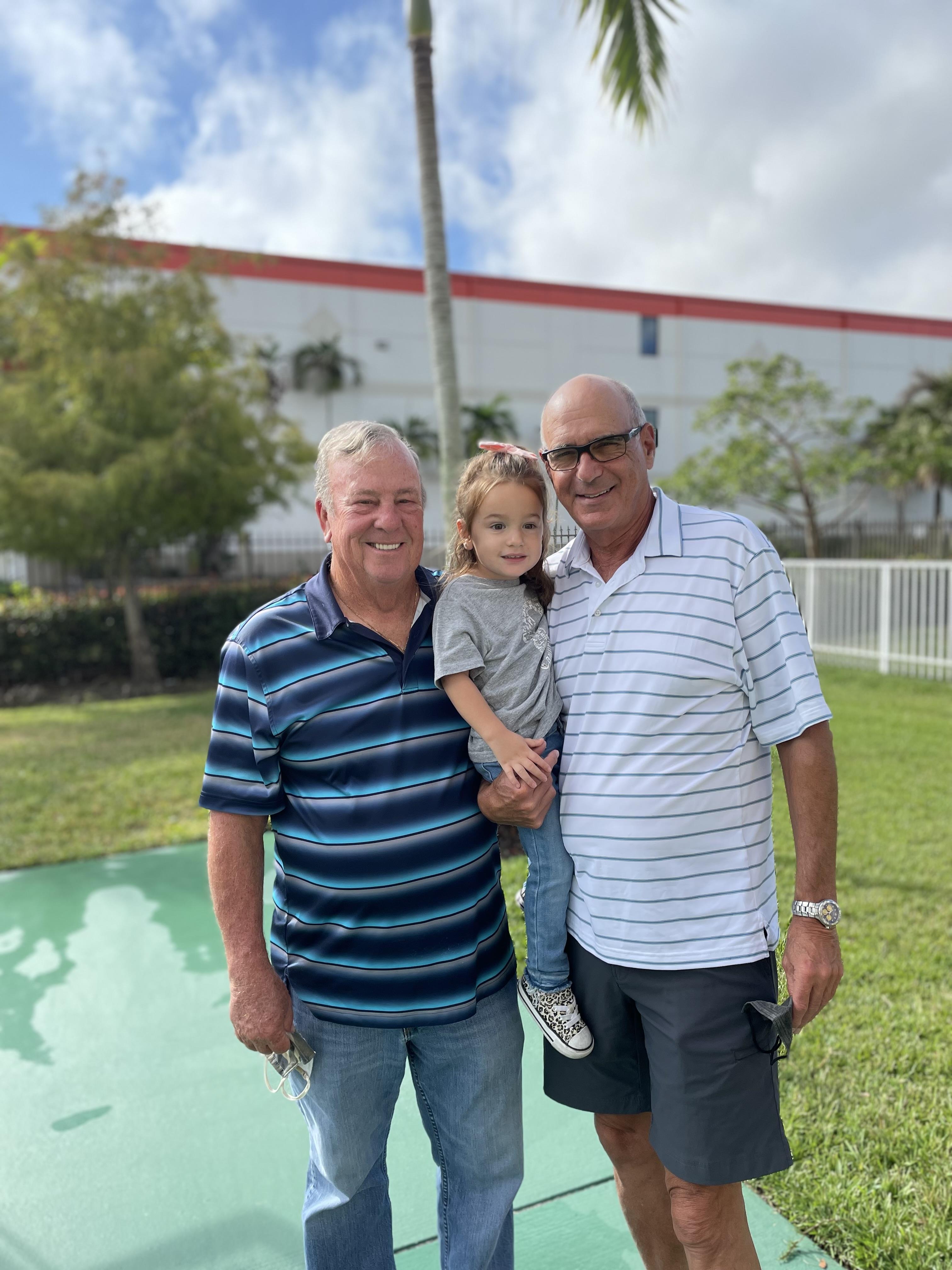 A group of men and a child posing for a picture