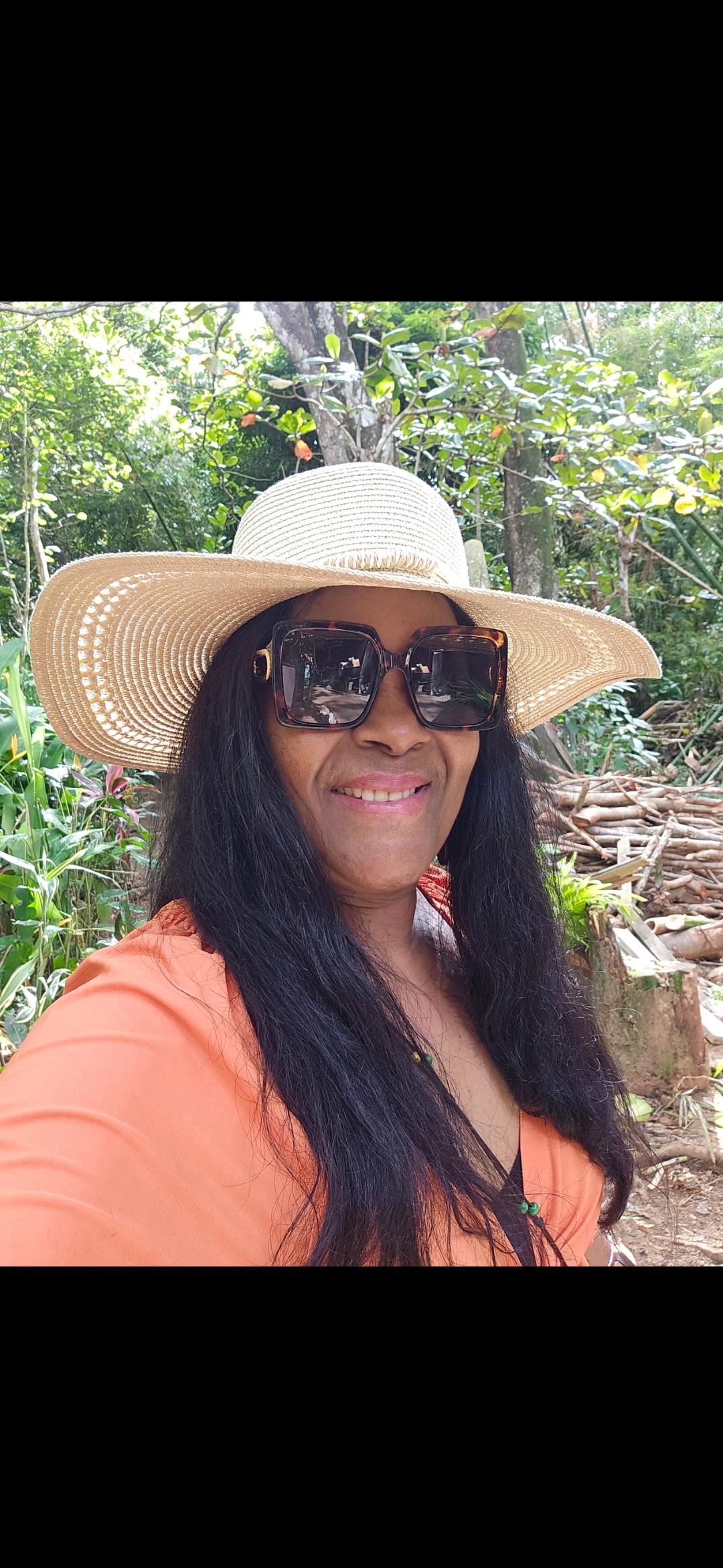 A woman wearing a hat and sunglasses